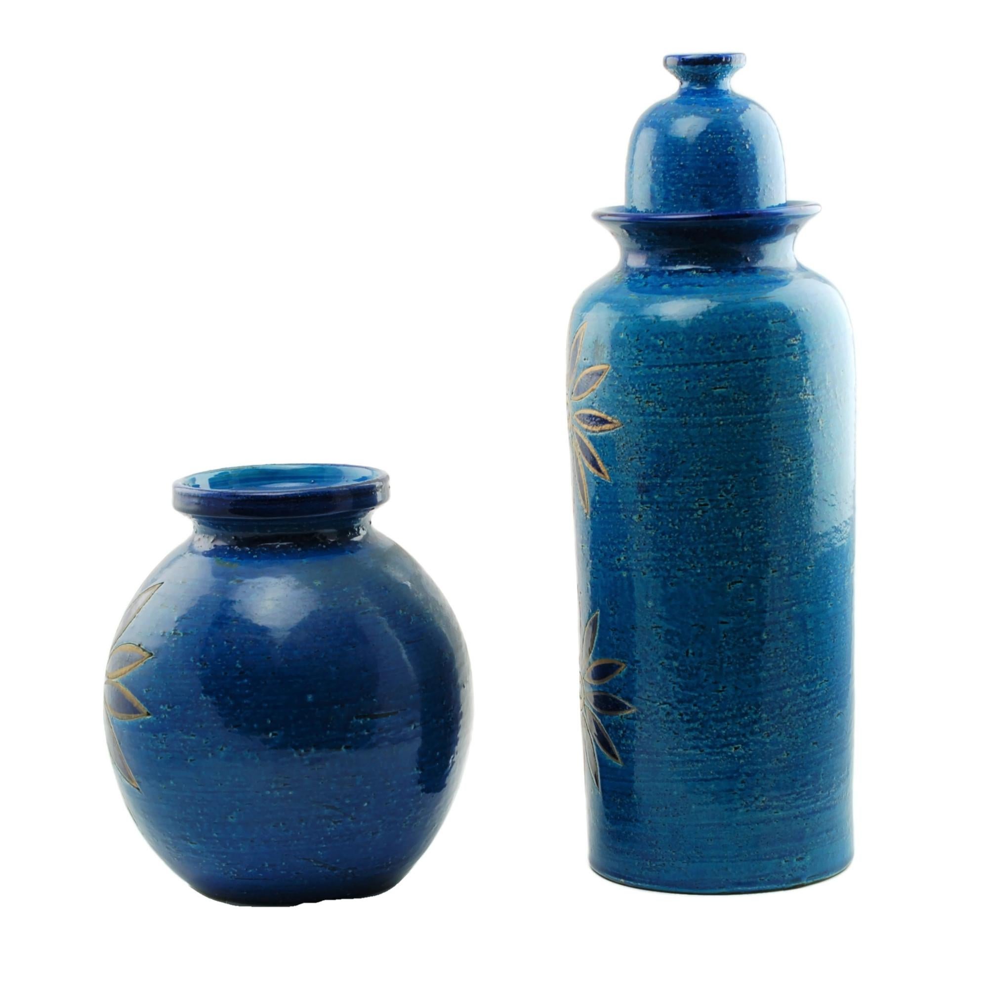 This ceramic vase and lidded jar were designed by Aldo Londi, art director for Bitossi ceramiche in Montelupo, Italy. Both pieces feature large stylized flowers and have been finished in Bitossi's rich Rimini blu glaze reminiscent of the Adriatic.