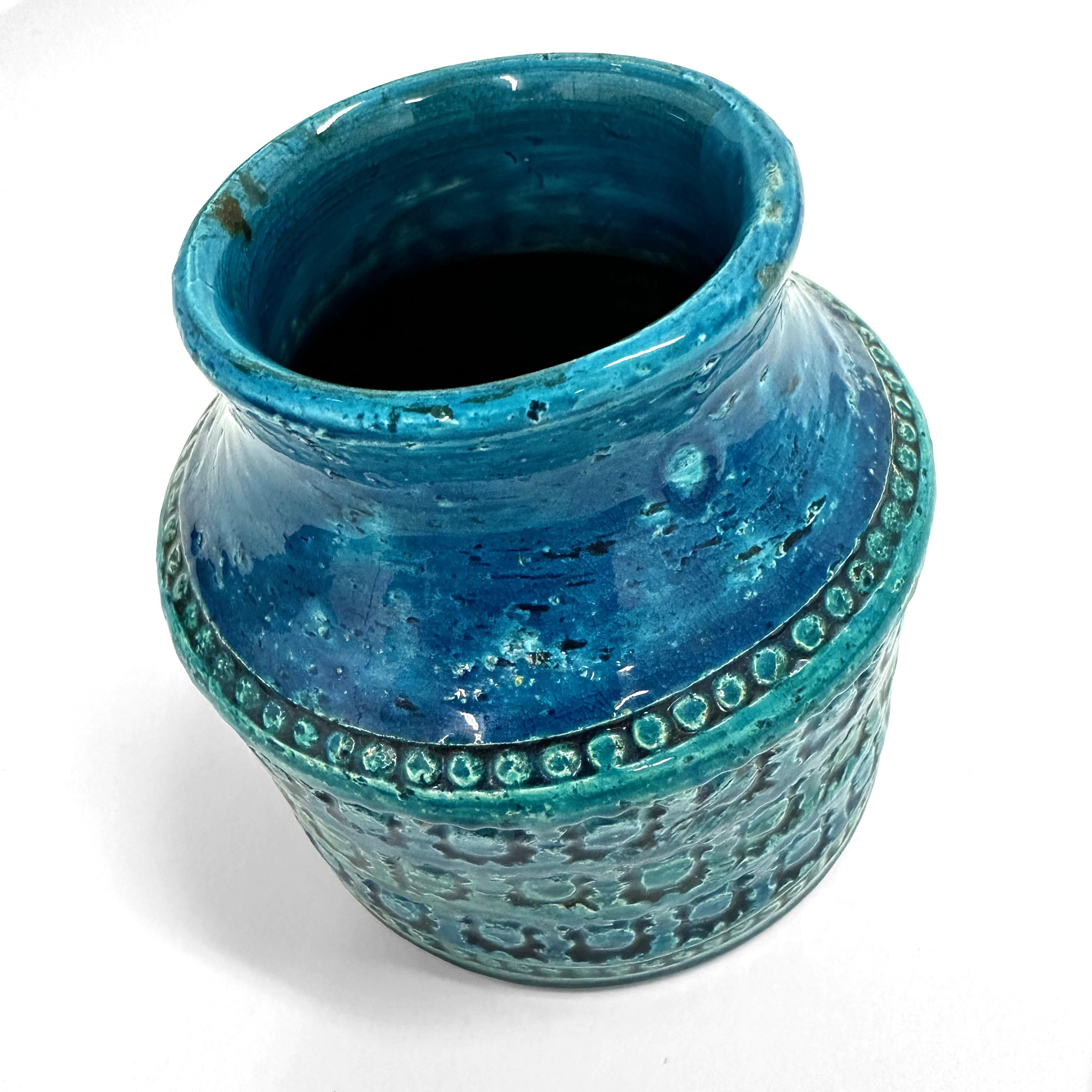 A wide-mouthed terracotta ceramic vase designed by Aldo Londi for Bitossi in Italy during the late 1950s or early 1960s.

Handcrafted in Italy with hand-stamped spectacular geometric designs in the glazed vibrant turquoise and cobalt blue that