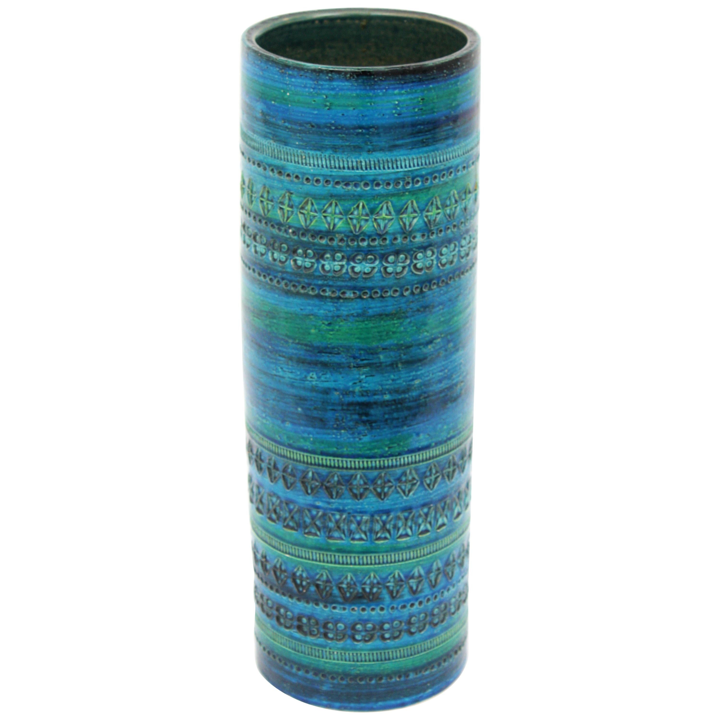 A giant sized handmade Rimini blue ceramic vase designed by Aldo Londi and manufactured by Bitossi. Italy, 1960s.
Blue glazed ceramic with engraved patterns adorning the top of the vase and the bottom. Its gorgeous shades of blue and green and the