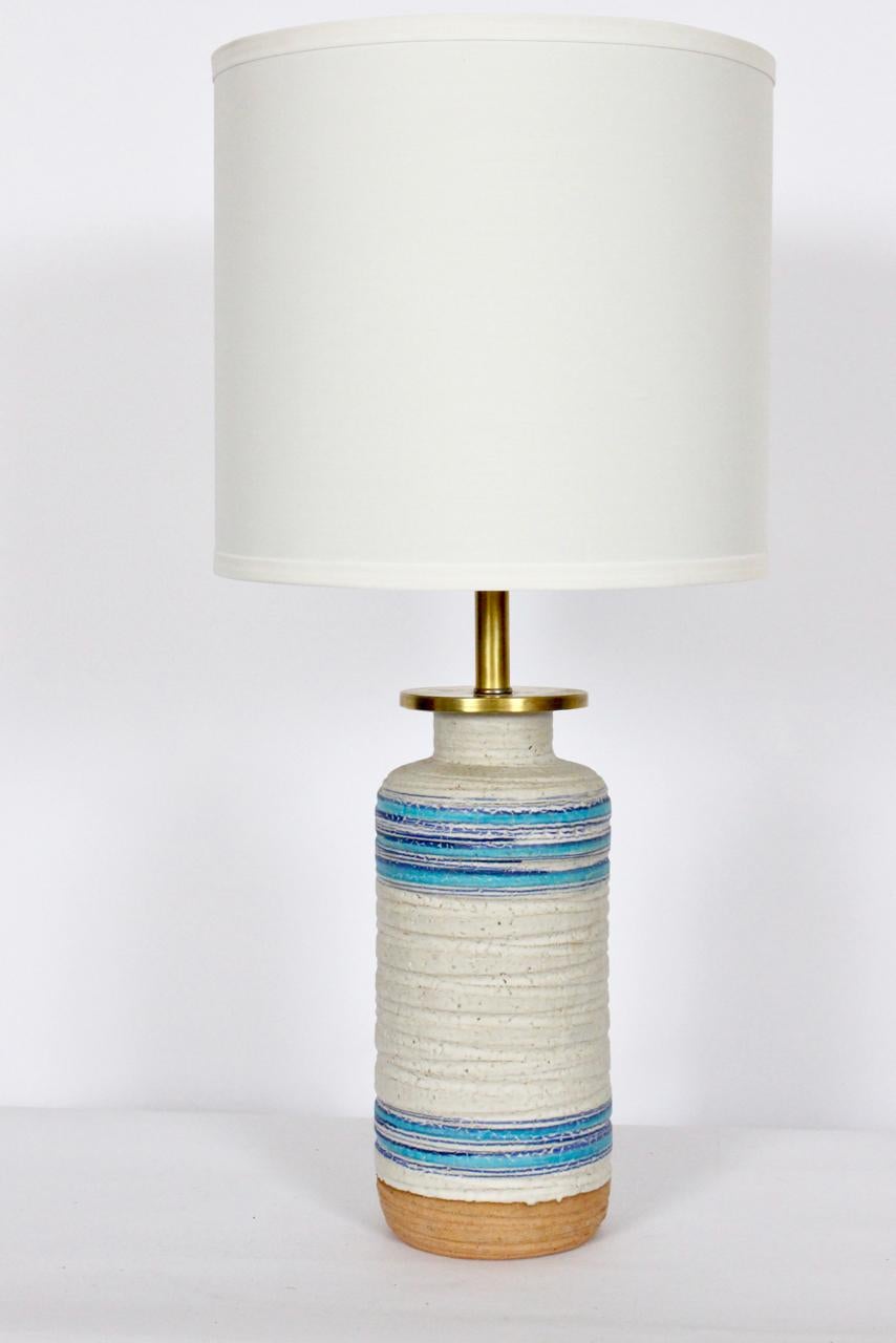 Aldo Londi attributed Rosenthal Netter off white and blue banded glazed ceramic table lamp. Handcrafted, textured, glazed Ceramic cylindrical form, incised details, Cream background, horizontal turquoise, bright Blue striping, drip glaze, exposed
