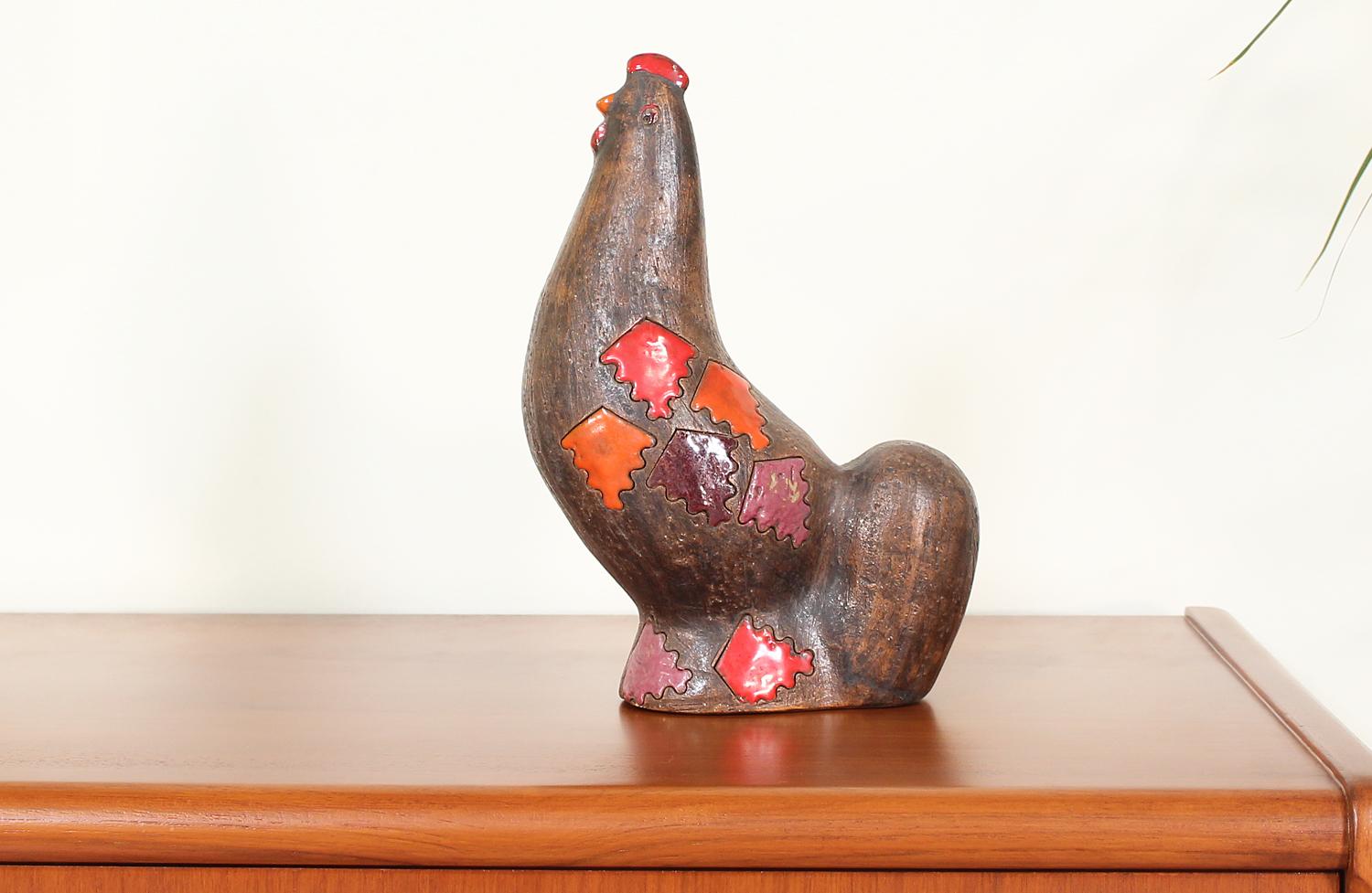 Lovely ceramic chicken figurine designed by Aldo Londi for Bitossi in Italy circa 1950’s. Featuring a glazed ceramic body in a dark earthy tone with different hues and textures. Its vibrant red, orange and mauve details play well with other