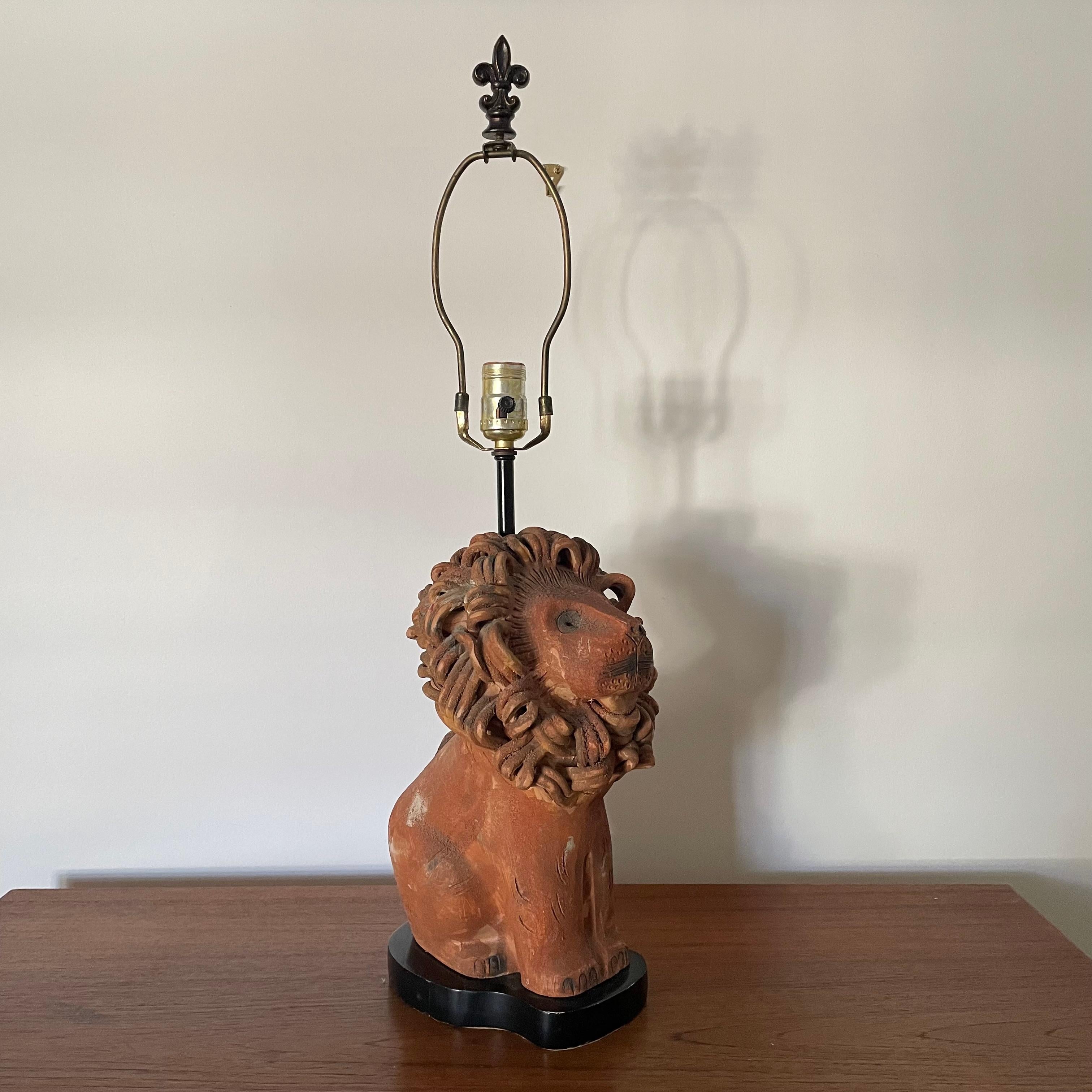Mid century pottery lion lamp by Aldo Londi for Bitossi, circa 1950.
Lamp is an unglazed pottery with detailed mane and face.
Mounted on a black wood base (some chipping paint) with original hardware/wiring in good working order. Composite
