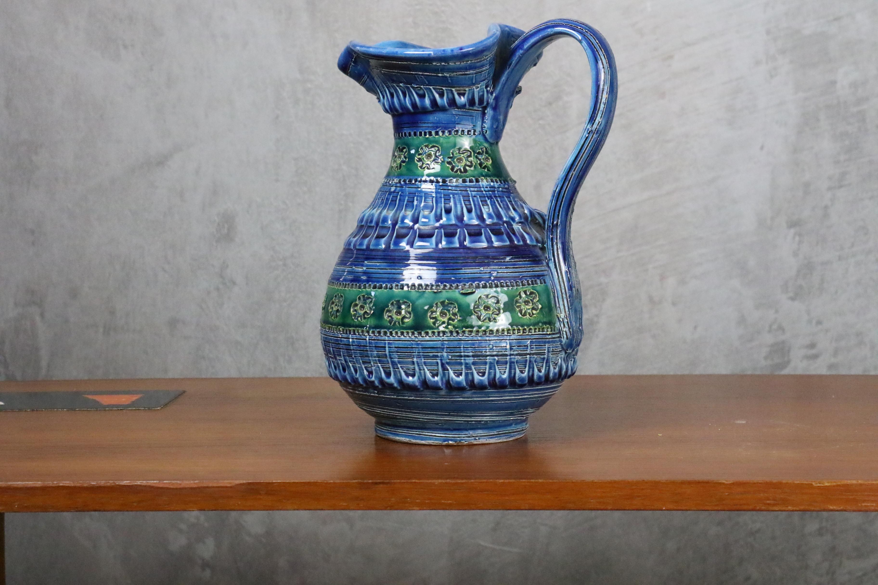 Aldo Londi Terracotta Ceramic Rimini Blue Vase or Pitcher for Bitossi, Italy. 

This magnificent vase was designed by Aldo Londi in Italy during 1960s.

Blue, green and turquoise terracotta ceramic are glazed by hand with a geometric design carved.