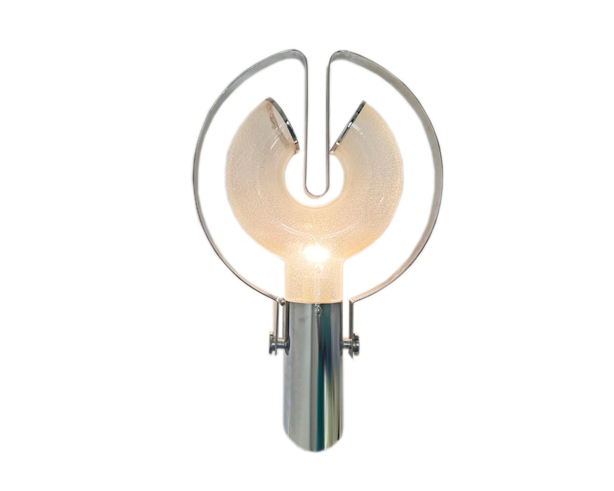 A Space Age wall sconce designed by the Italian designer Aldo Nason (born 1920) for Mazzega. Made in Murano, Italy, the sconce has a ﻿﻿pulegoso-like glass shade filled with small bubbles throughout. The shade is held within a chrome tube wall mount