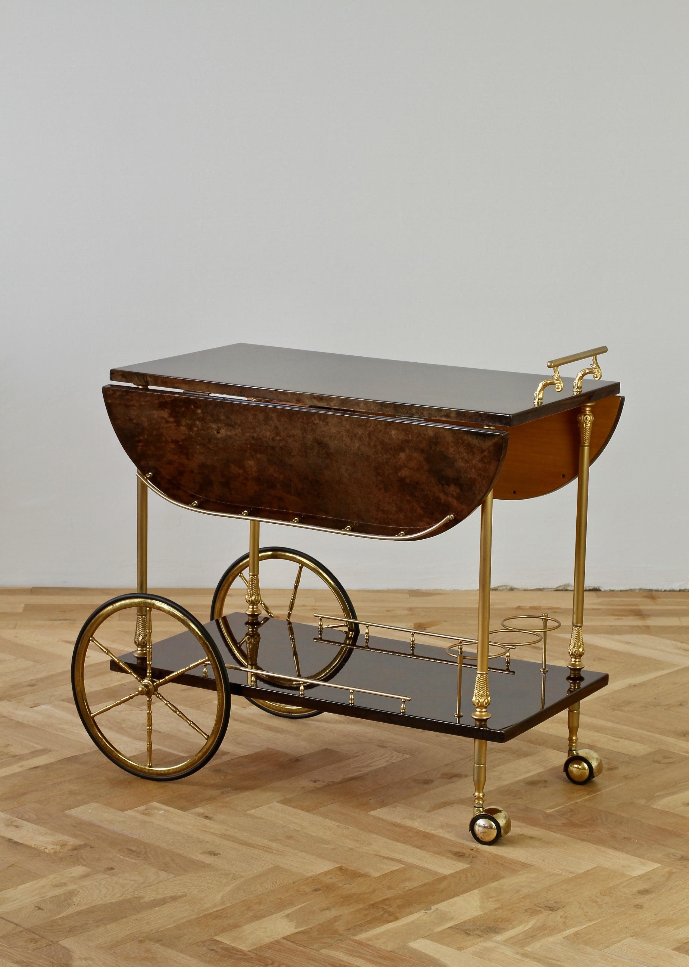 Large Aldo Tura Italian bar cart, drinks trolley or stand with curved drop-leaf extensions, made in Milan, circa 1968. Aldo Tura was a master craftsman using the finest materials he created such wonderful pieces such as this. Using a deep brown