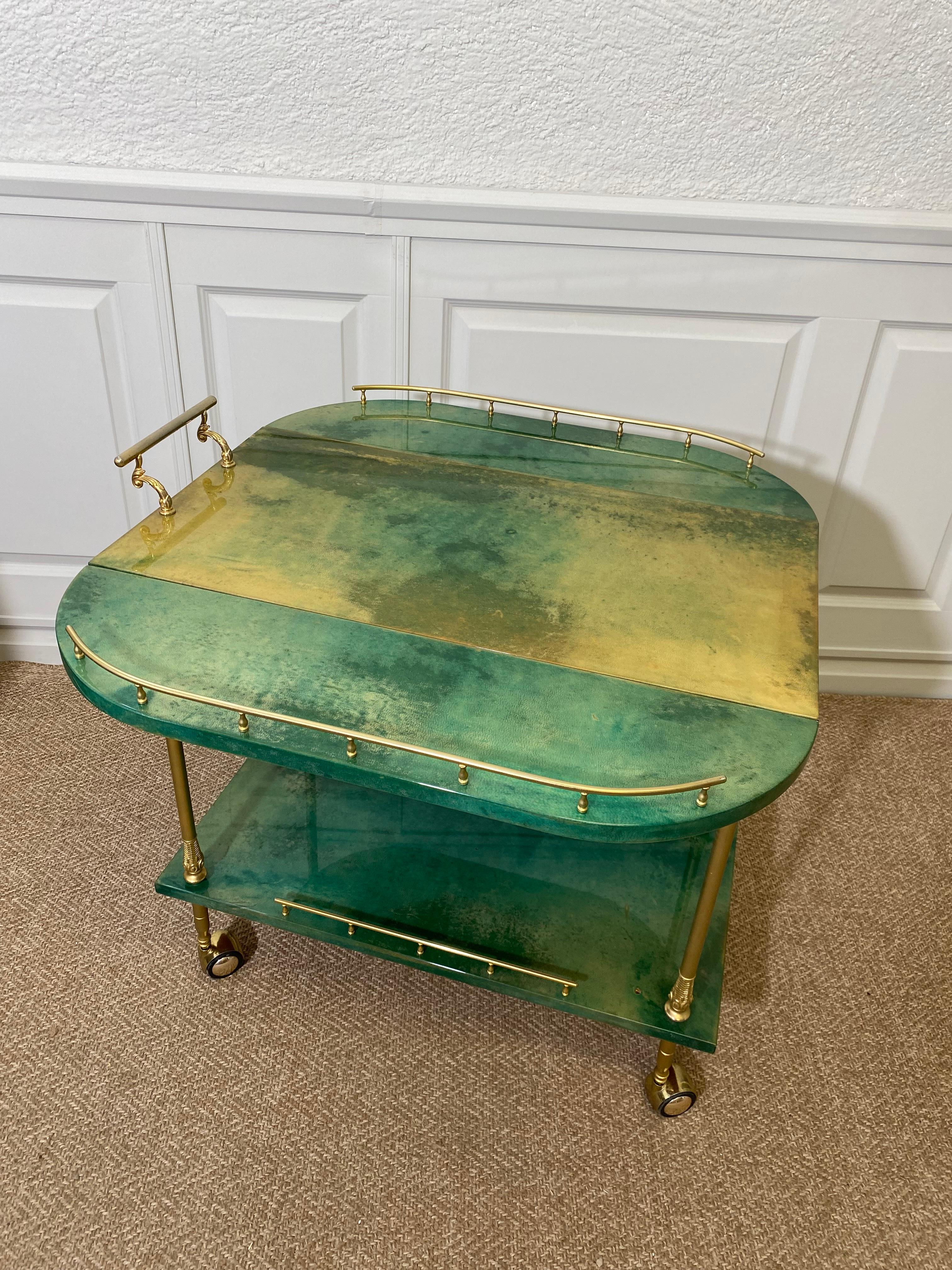 We love Aldo Tura bar carts! Check out our store for more Aldo Tura designs!

With its distinctive, sleek design this turquoise ALDO TURA bar cart is made of high-quality materials and finishes. 

This beautiful example features two foldable sides