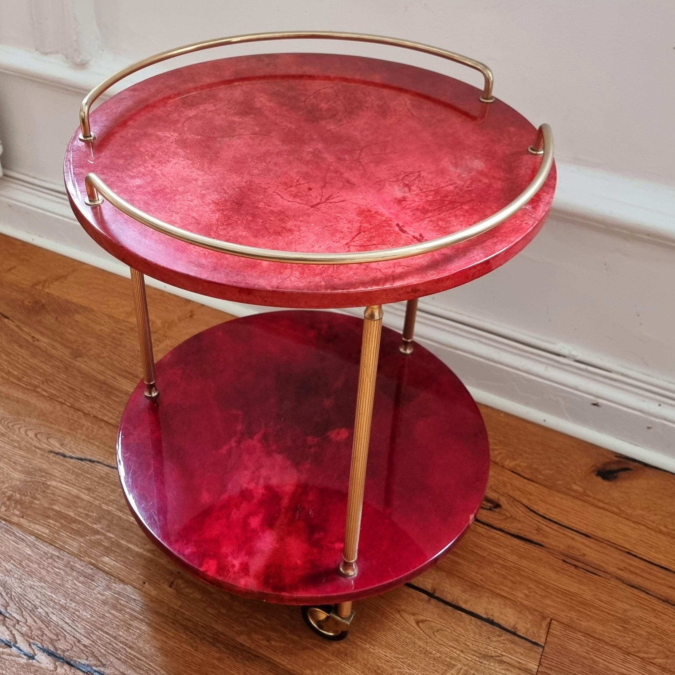Two story bar cart by italian designer Aldo Tura. In wood with colored goatskin and transparant lacquer. 

Aldo Tura (1909-1963) began manufacturing his signature furniture in the 1930s, focusing on limited production of handcrafted designs