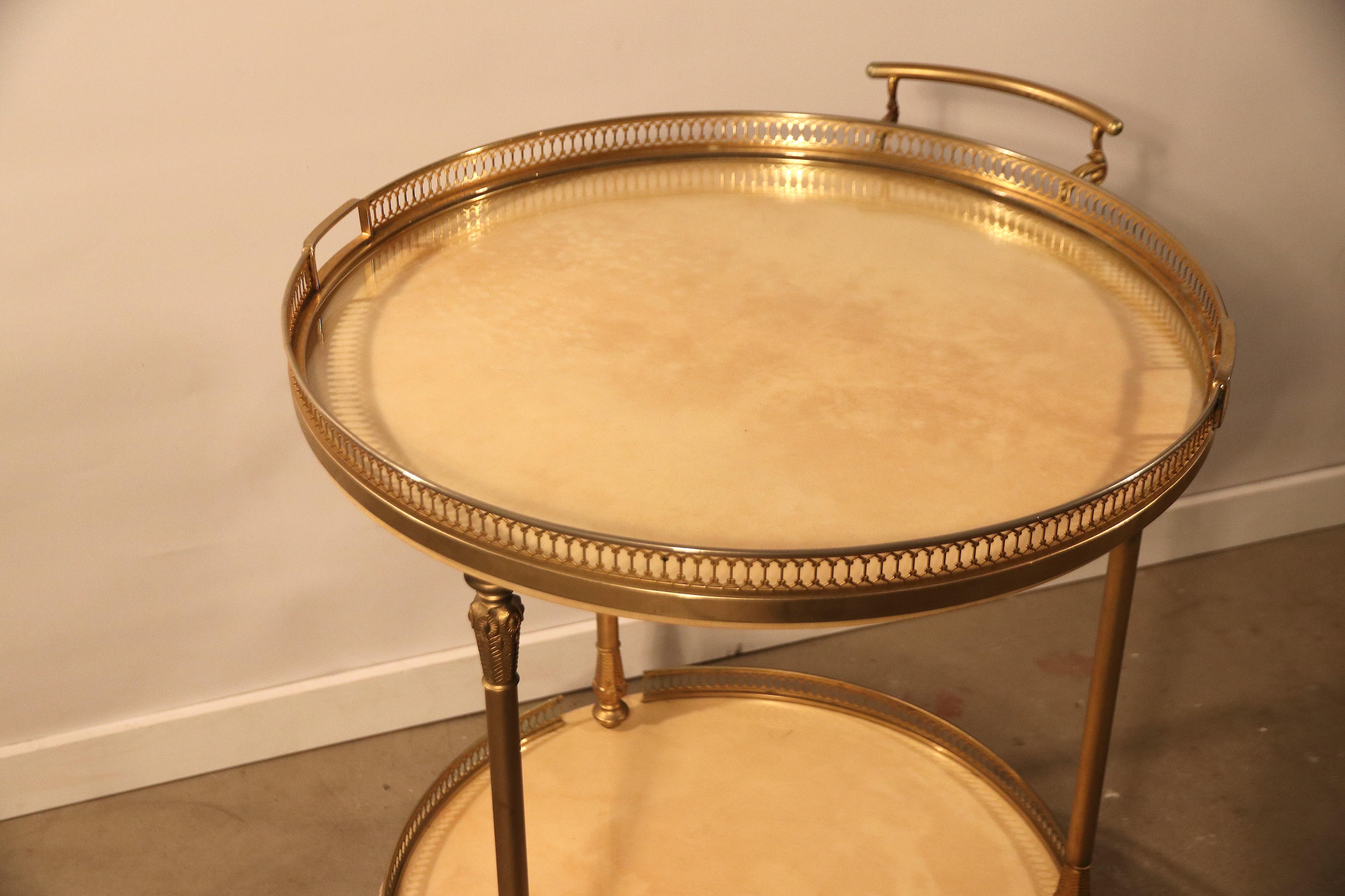 Astonishing piece designed and signed by Aldo Tura in vivid-crème yellow-brown dyed goatskin leather or parchment. This is a 2-tier bar cart or tea / serving drinks trolley on 3 beautifully covered typically 1950s streamline brass casters. The top