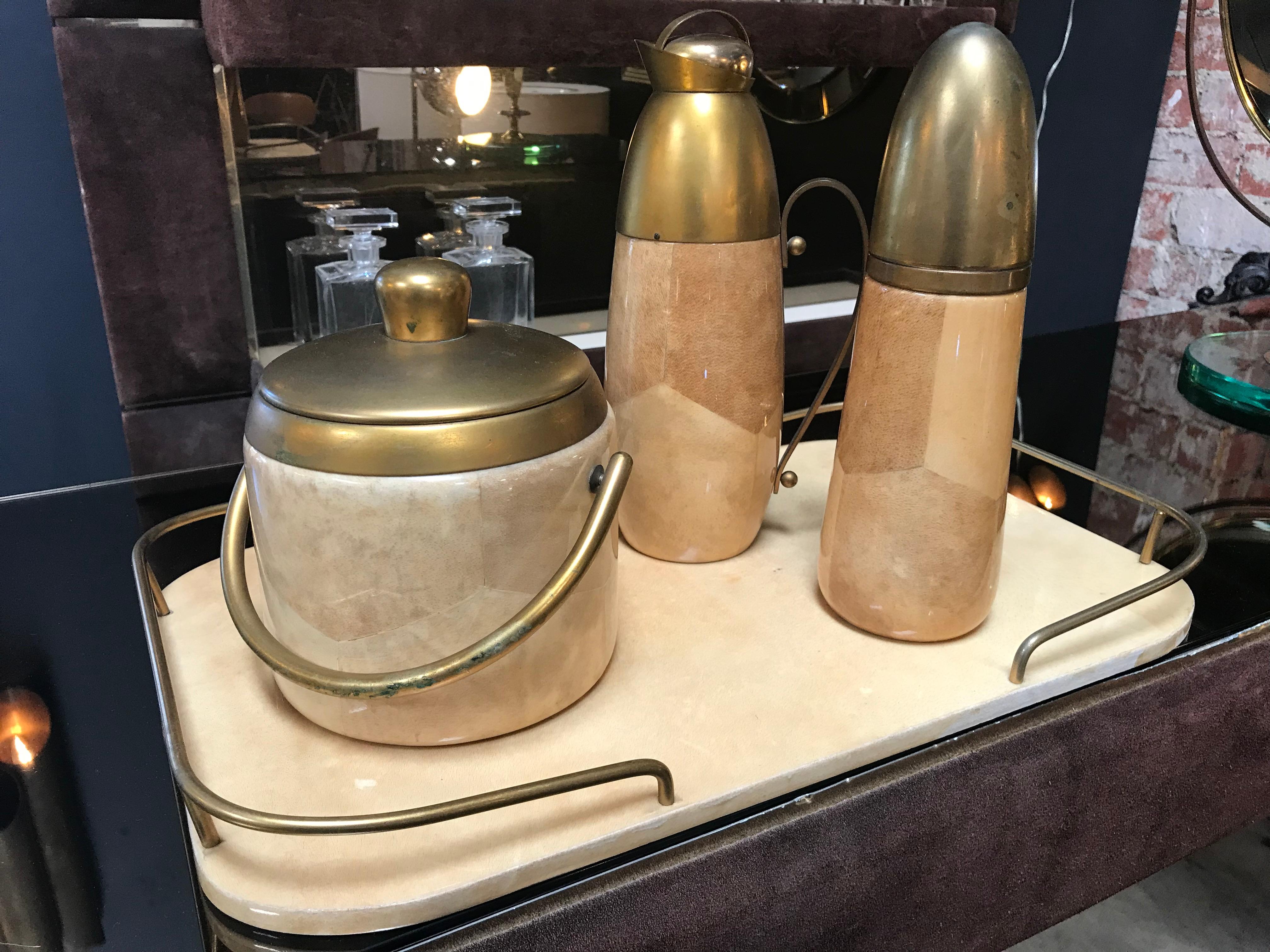 Aldo Tura Barware Set in Brass and Parchment, Italy, 1950s
Set includes a tray with original mirror and sculptural brass handles; a carafe with original matching lid, a shelter and an Ice Bucket.
All original set signed in very good