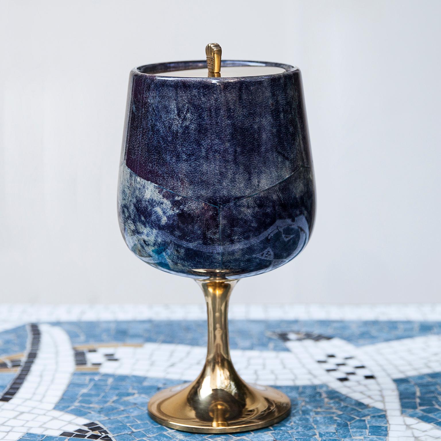 Wonderful ice bucket of Aldo Tura in lacquered goatskin.
This ice bucket was executed, circa 1960 in a blue parchment and brass applications and a glass inlay. Along with artists like Piero Fornasetti and Carlo Bugatti, Aldo Tura (1909-1963)