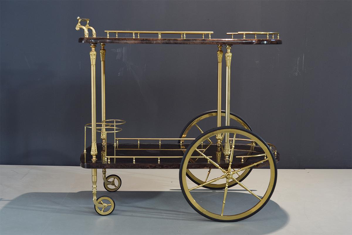 Very style-full bar cart or serving cart designed by Aldo Tura. Made off elegant lacquered dark brown goatskin and brass decorative supports and wheels. Very decorative piece.