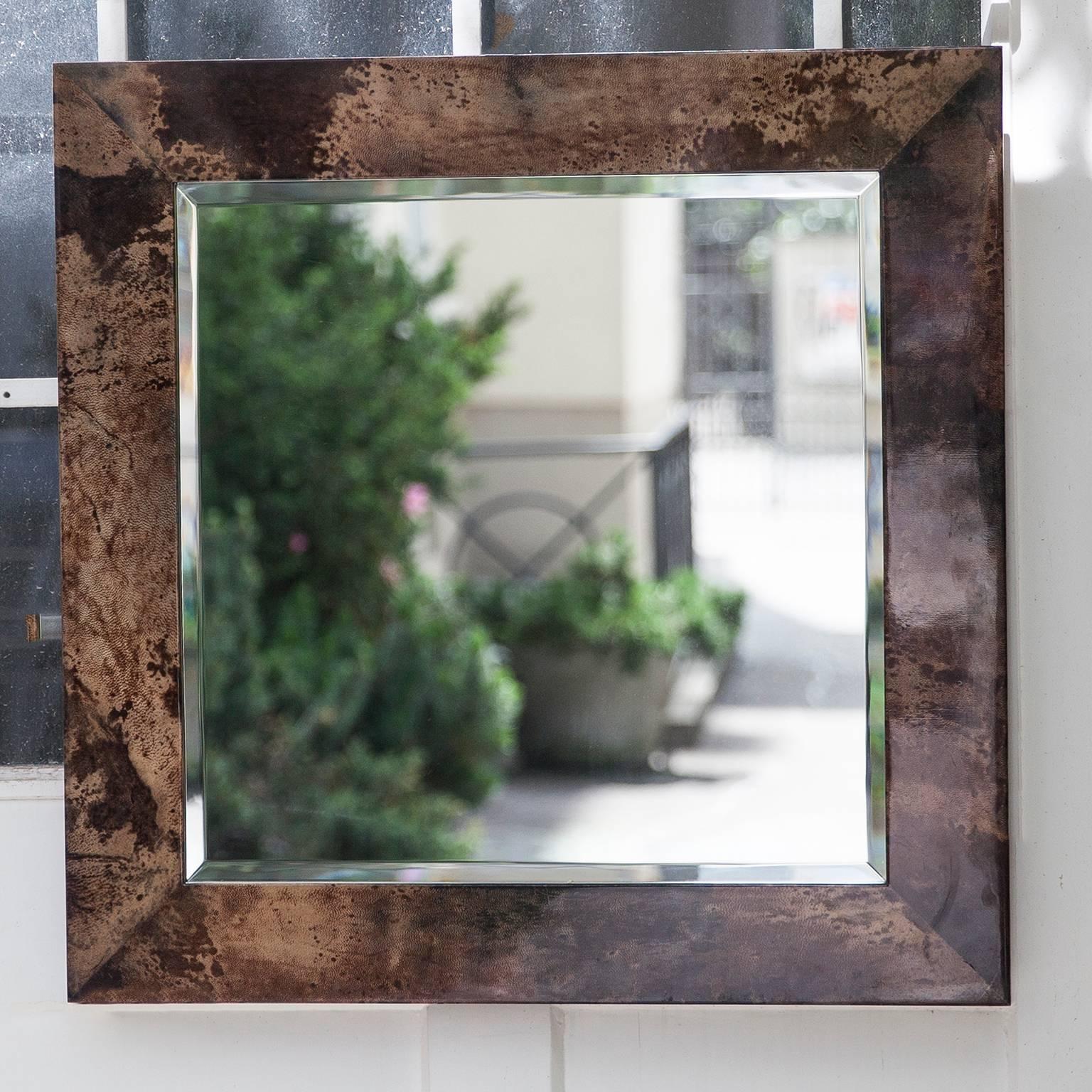 Aldo Tura chocolate brown goatskin parchment wall mirror, Italy, 1960s
Measures: 70 H x 70 B x 2 D cm.
Along with artists like Piero Fornasetti and Carlo Bugatti, Aldo Tura (1909-1963) definitely belonged to the mavericks of Italian design.