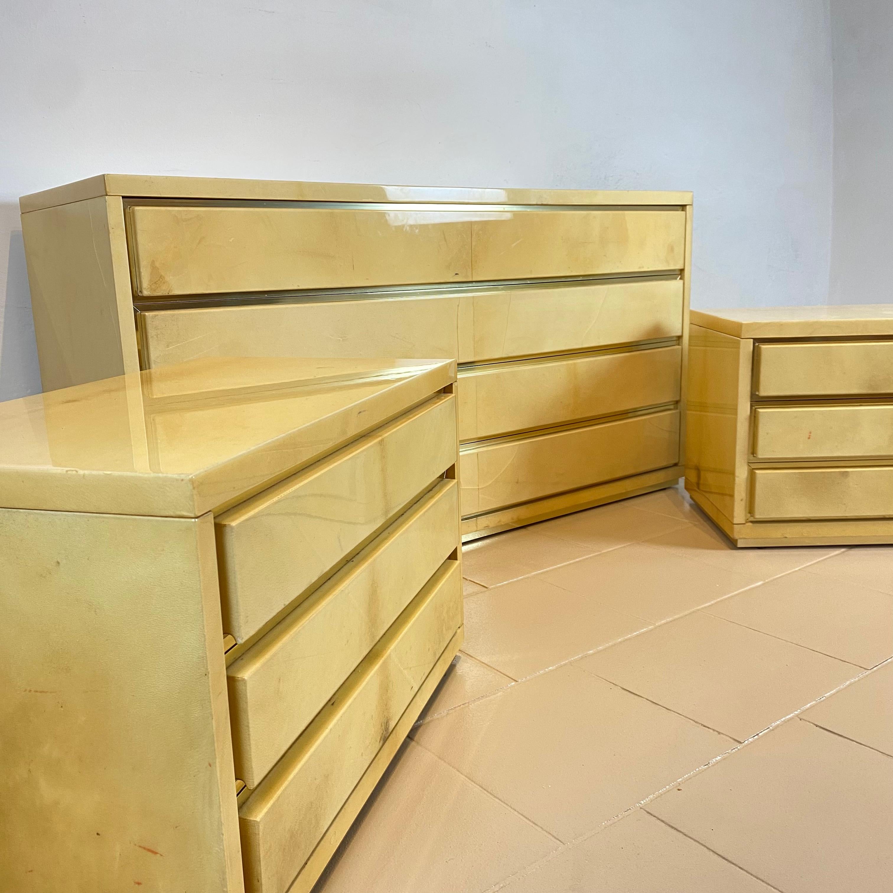 Mid-20th Century Aldo Tura Chest of Drawers and a Pair of Nightstands in Parchment and Brass