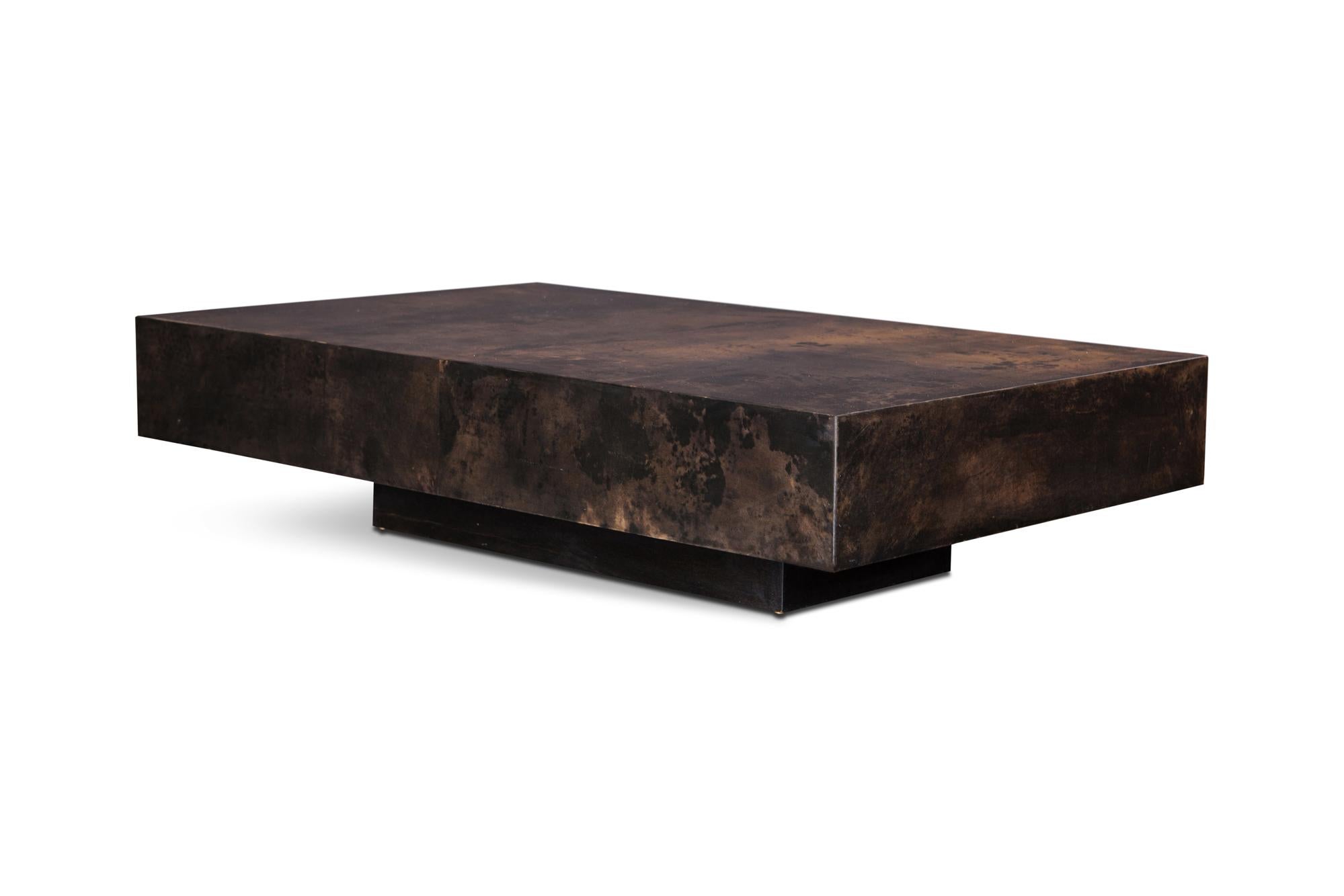Coffee table by Italian designer Aldo Tura. 

The table is made of brown lacquer, giving it a surface covered in beautiful colours, and patterns. The table has a floating appearance due to the hidden base. This particular example is a bit larger