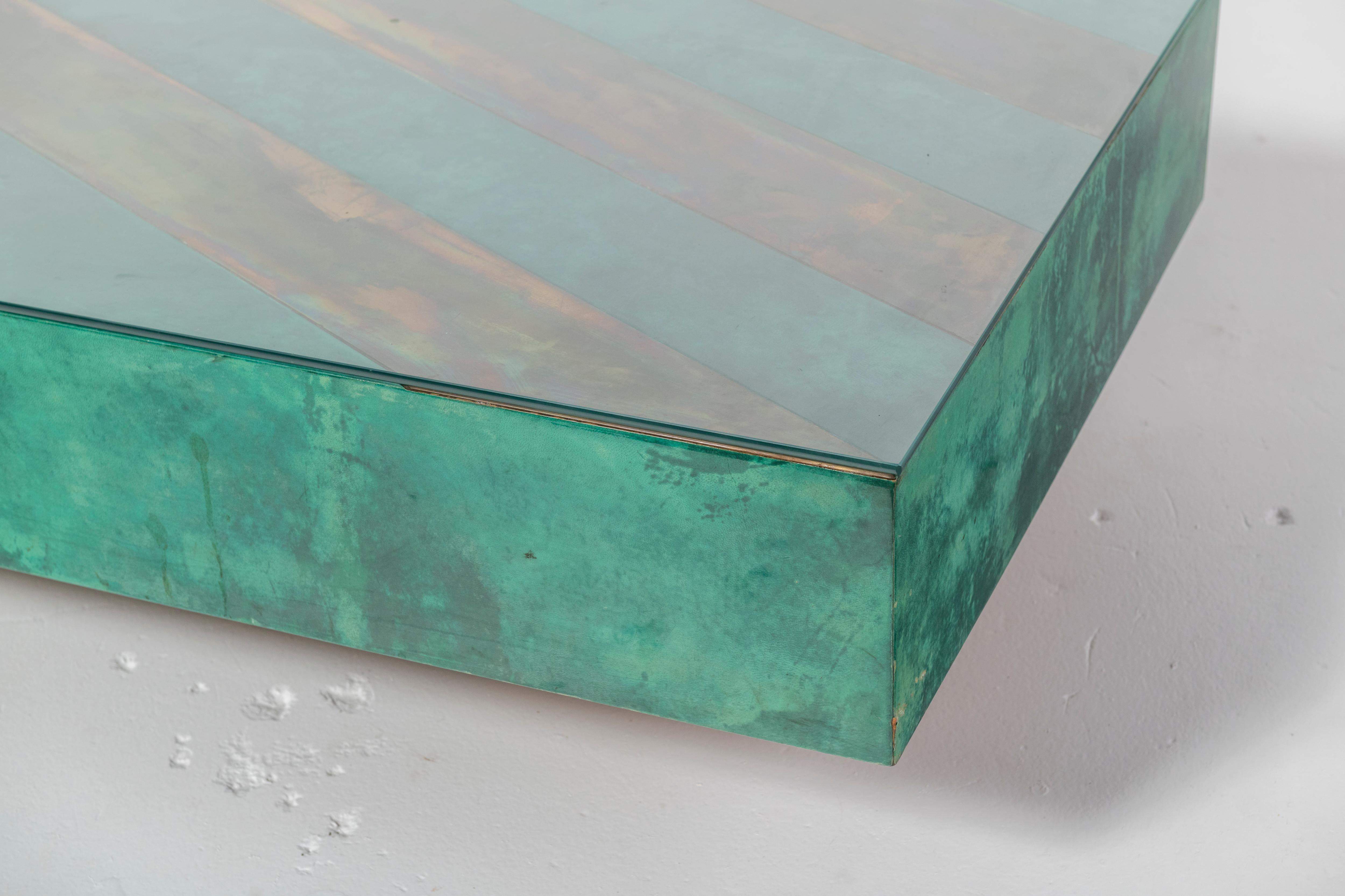 This is an unusual Aldo Tura large rectangular coffee cocktail table in emerald green parchment with diagonal brass inlay. The top is lacquered for beauty and preservation. 

Aldo Tura's timeless, modern design ensures many years of enjoyment.