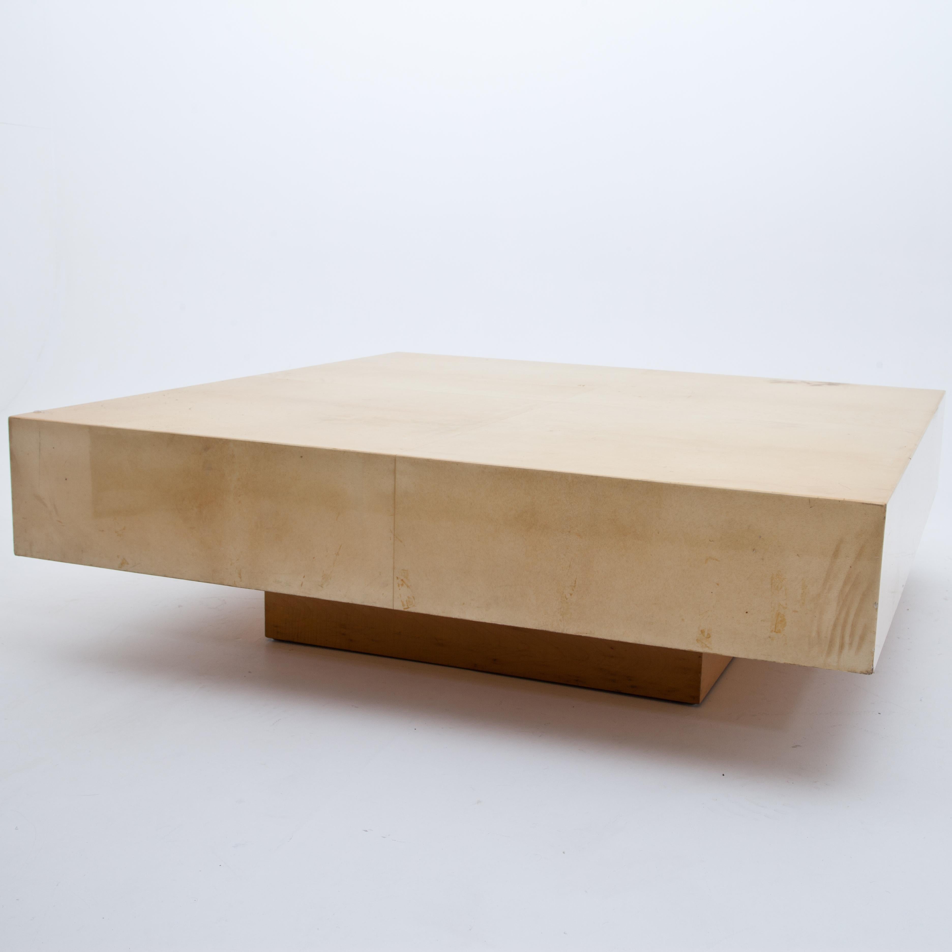 Square coffee table by Aldo Tura on a likewise square stand. The coffee table was covered with beige goat skin and sealed with clear varnish.
