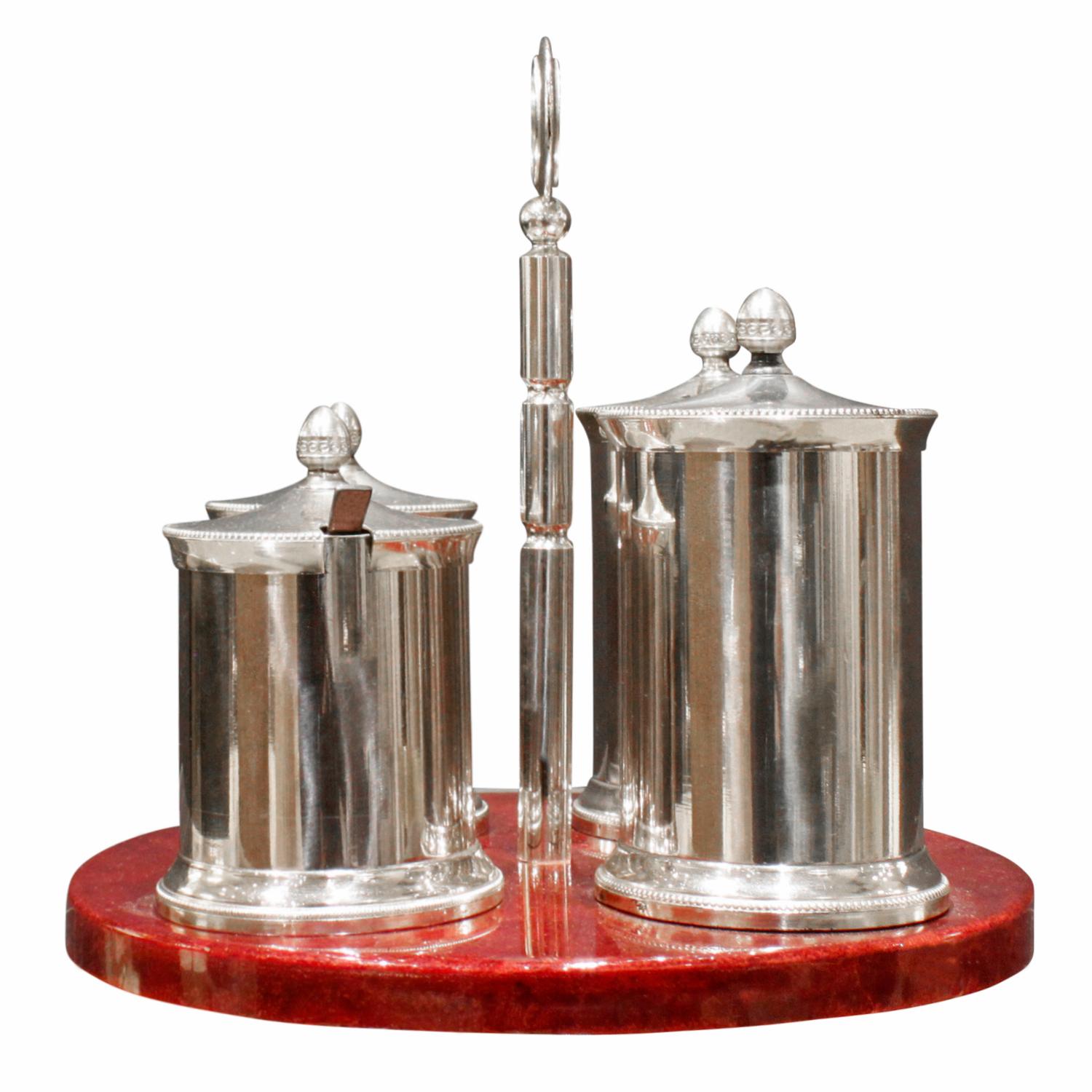 Cruet set with base in red lacquered goatskin with inset rosewood coasters and stainless steel containers and hardware by Aldo Tura it comes with Steuben Sterling silver spoon, Italy 1970s (signed on bottom with Tura label). This is a rare and very