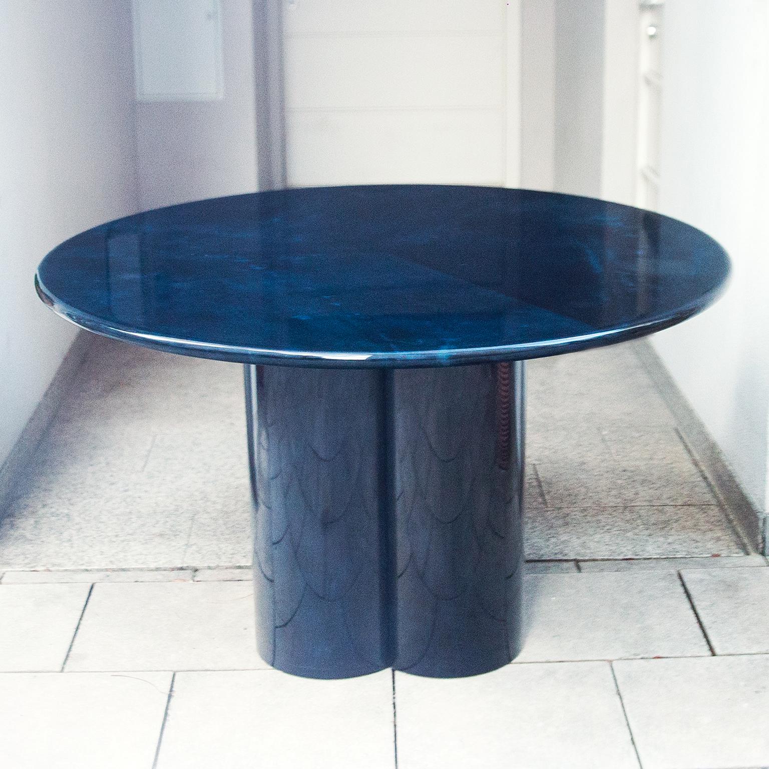 Elegant Aldo Tura parchment round dining table is based on iconic four-column stand.

This particular dining table was executed in the late 1970 and is in excellent condition.

Along with artists like Piero Fornasetti and Carlo Bugatti, Aldo