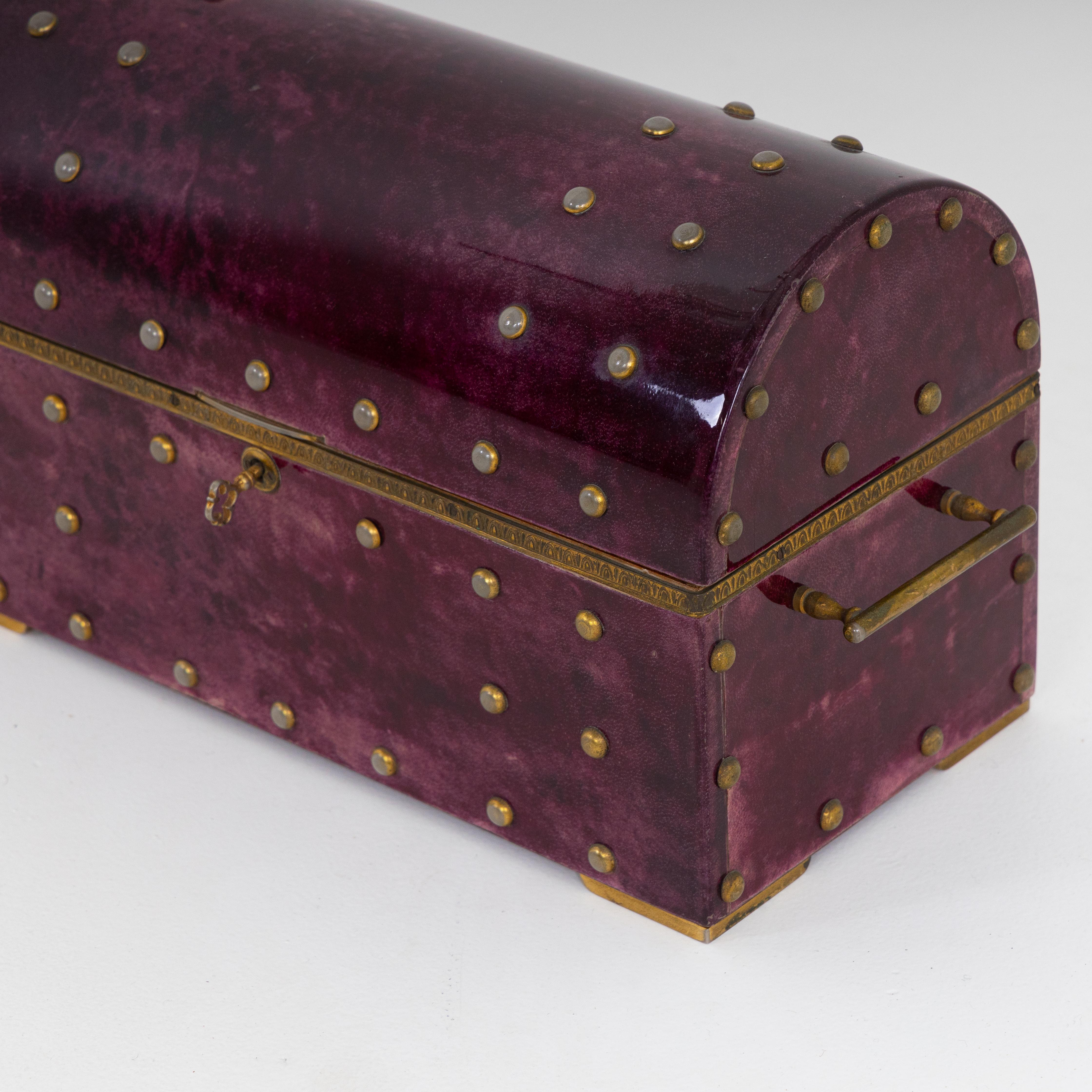 Aldo Tura designed goatskin box. Lacquered goatskin and brass details.
Incudes some vintage cards and chess pieces.