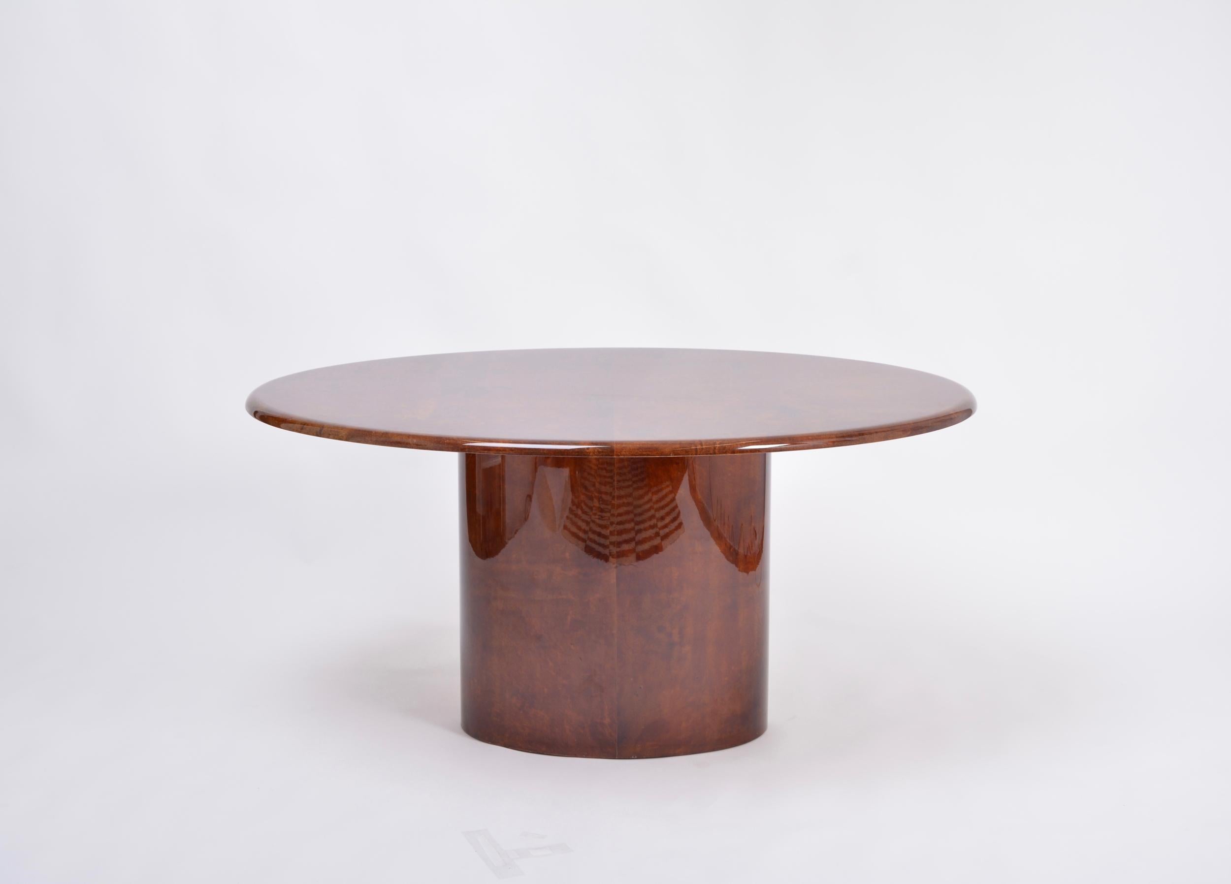Elliptically shaped dining table designed by Aldo Tura and produced in Italy in the 1970s. This dining table is a very strong example of his work, simple in form, with a soft curved top affixed to an elliptic pedestal base. The ethereal lacquered