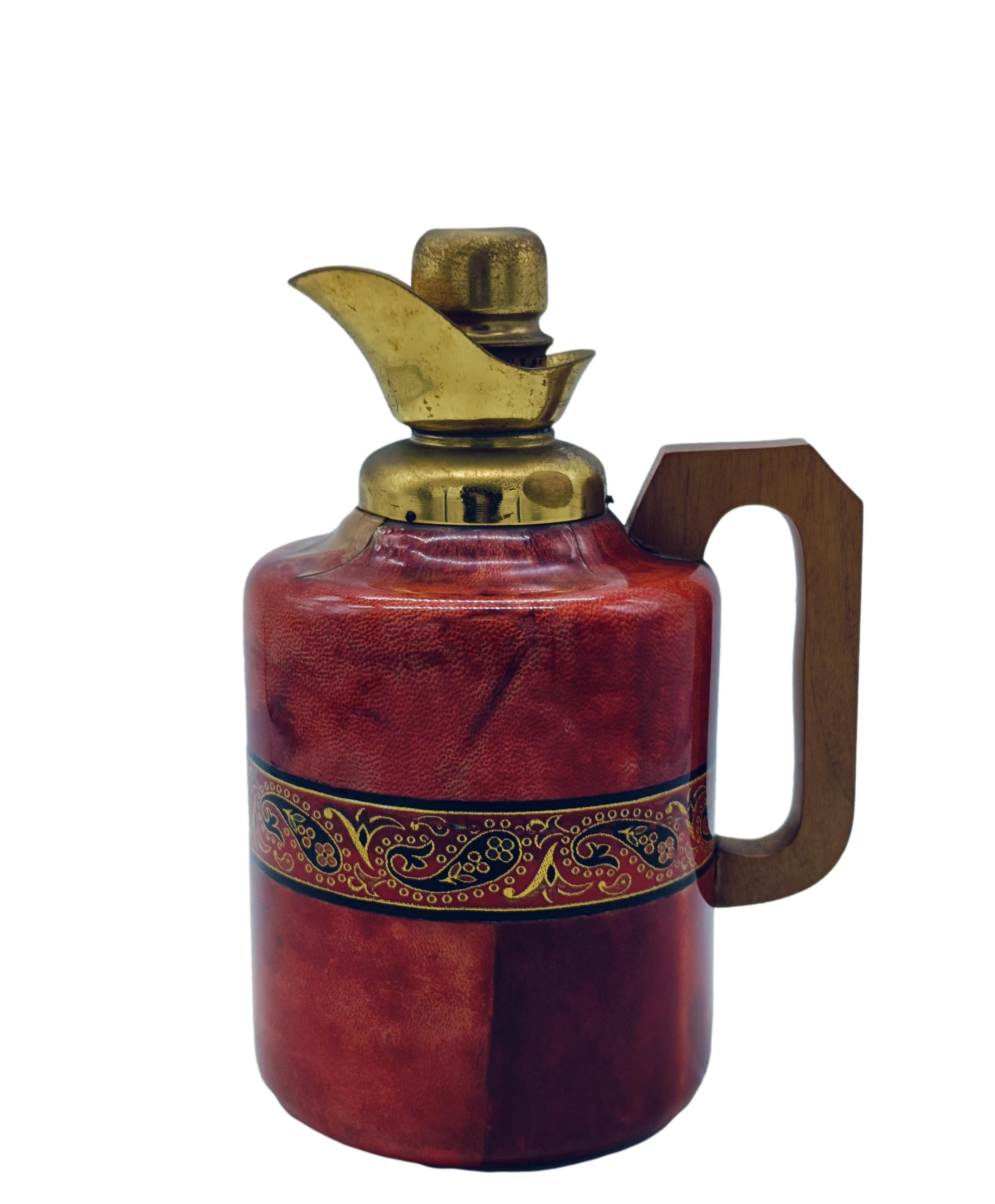 A beautiful goatskin and brass jug with some glass inlays and a wooden handle. A real eye-catcher designed by Aldo Tura for Macabo in the 1960s