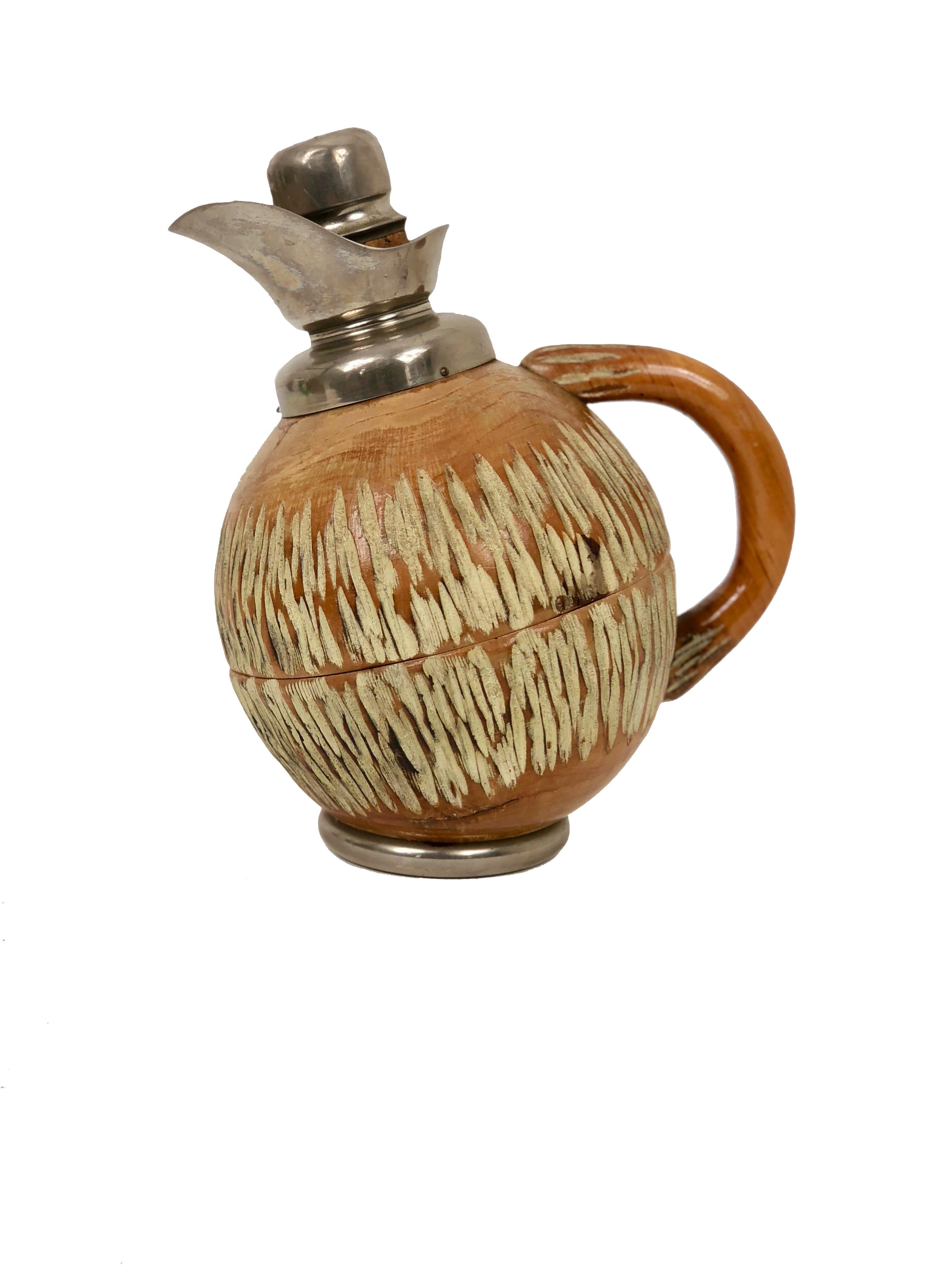 Thermos/decanter by the Italian Aldo Tura made of hand-carved wood and metal in a walnuts shape. 

The stamp is engraved on the bottom.