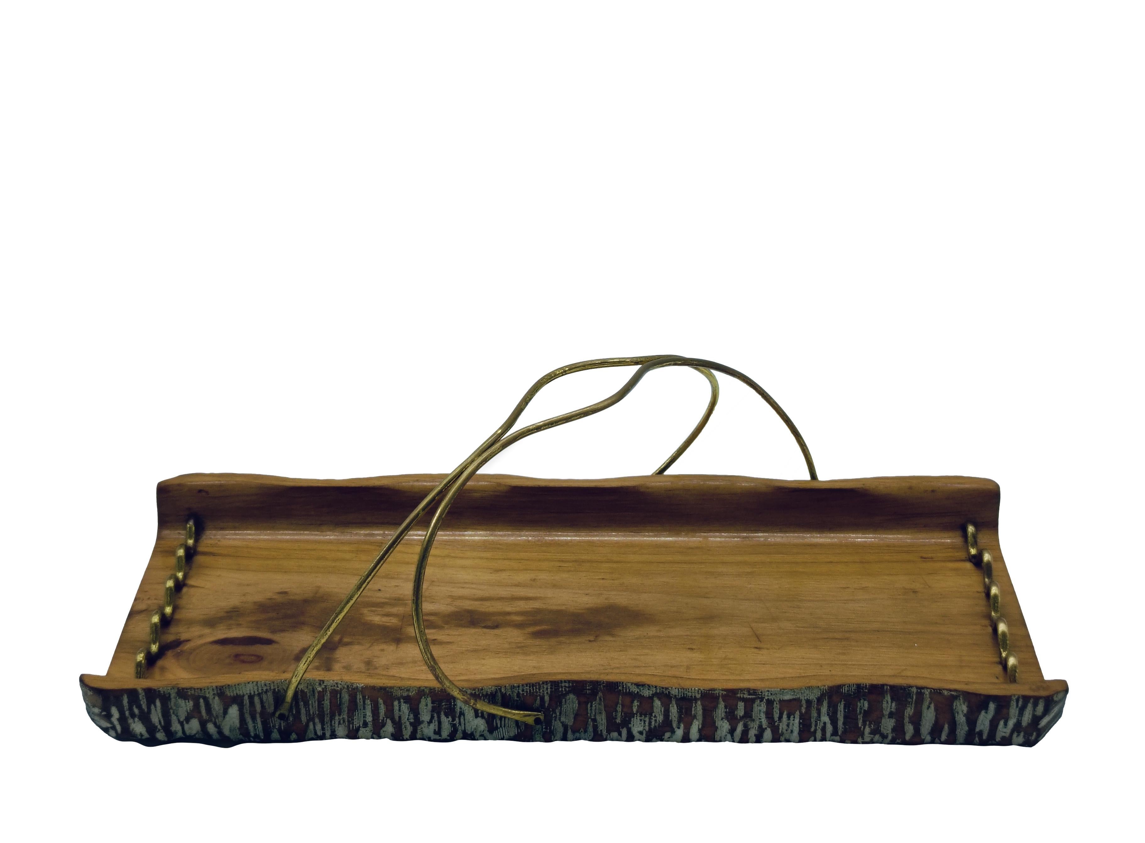 A beautiful and elegant carved wooden and brass serving tray by Aldo Tura for Macabo. It is in excellent condition and is signed on the bottom.