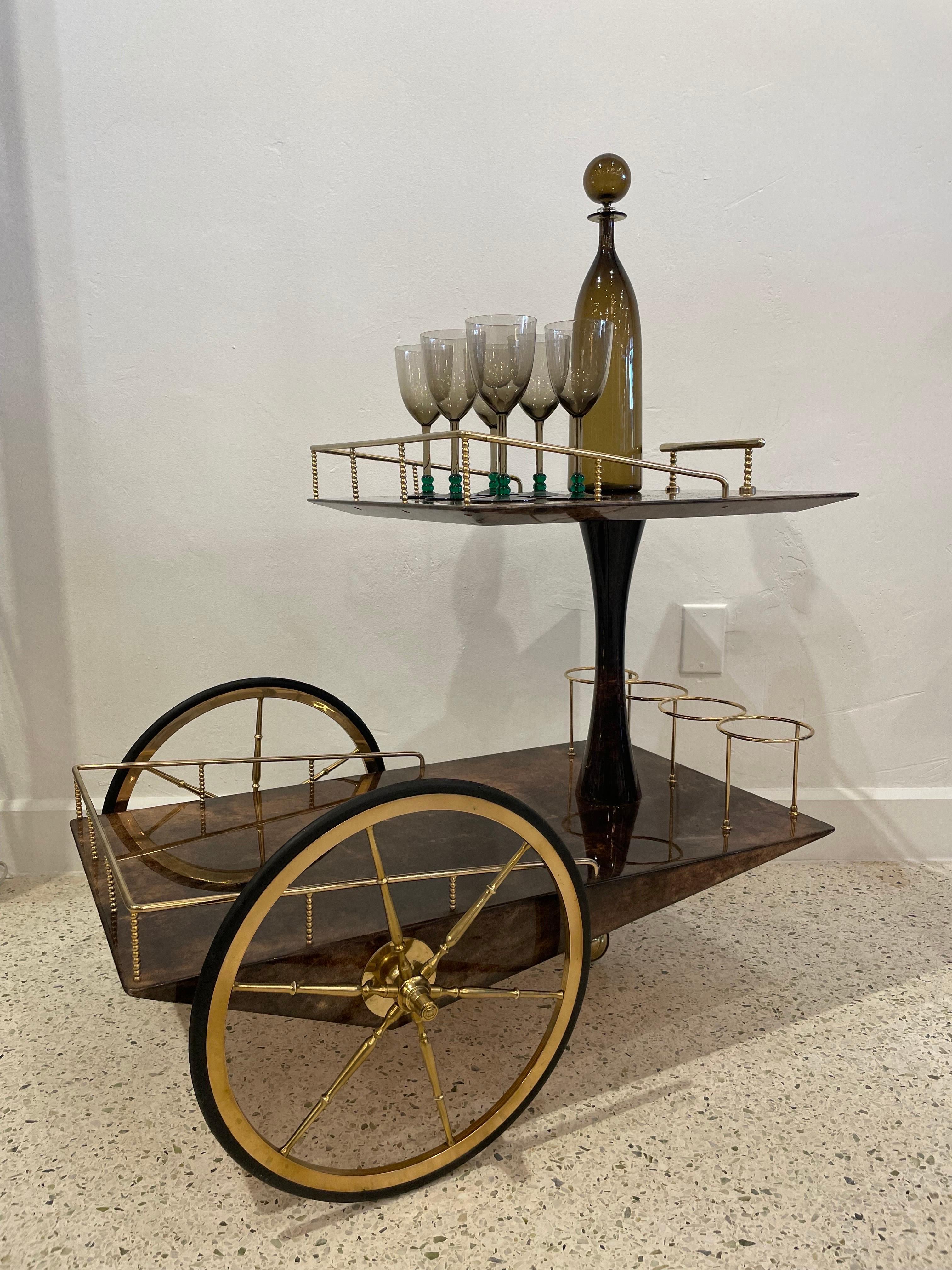 An original vintage Aldo Tura bar cart in dark brown lacquered goatskin and gold plated metal. Very geometric design and is a classic Italian Mid-century modern look. Signed underneath.