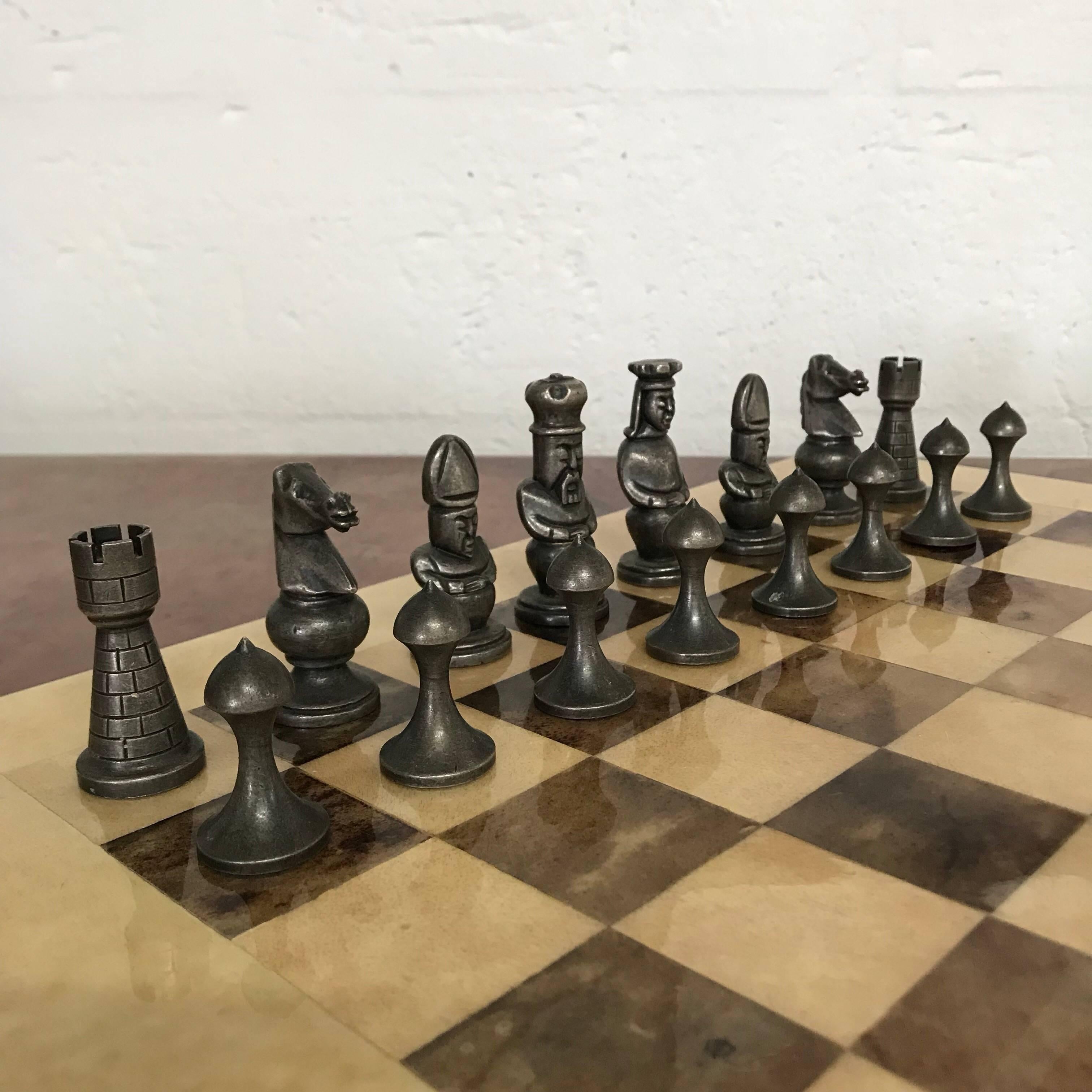 Chess set rendered in two-tone checkerboard goatskin and white and gold bronze chess pieces, designed by Aldo Tura, Italy, 1960s.
