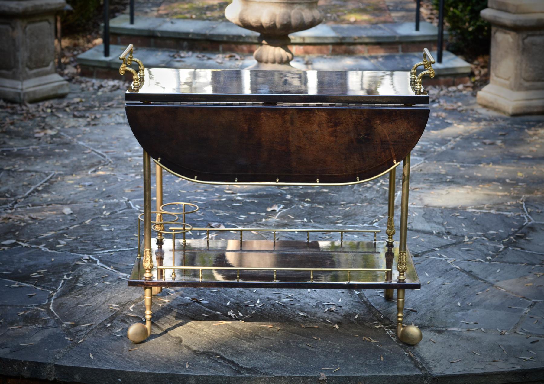 An iconic bar cart / trolley of lacquered goatskin in a fetching tobacco brown with gilt brass hardware by esteemed Italian designer Aldo Tura. Labelled underside, the mid 1960s drink server brings all the right classic and sophisticated