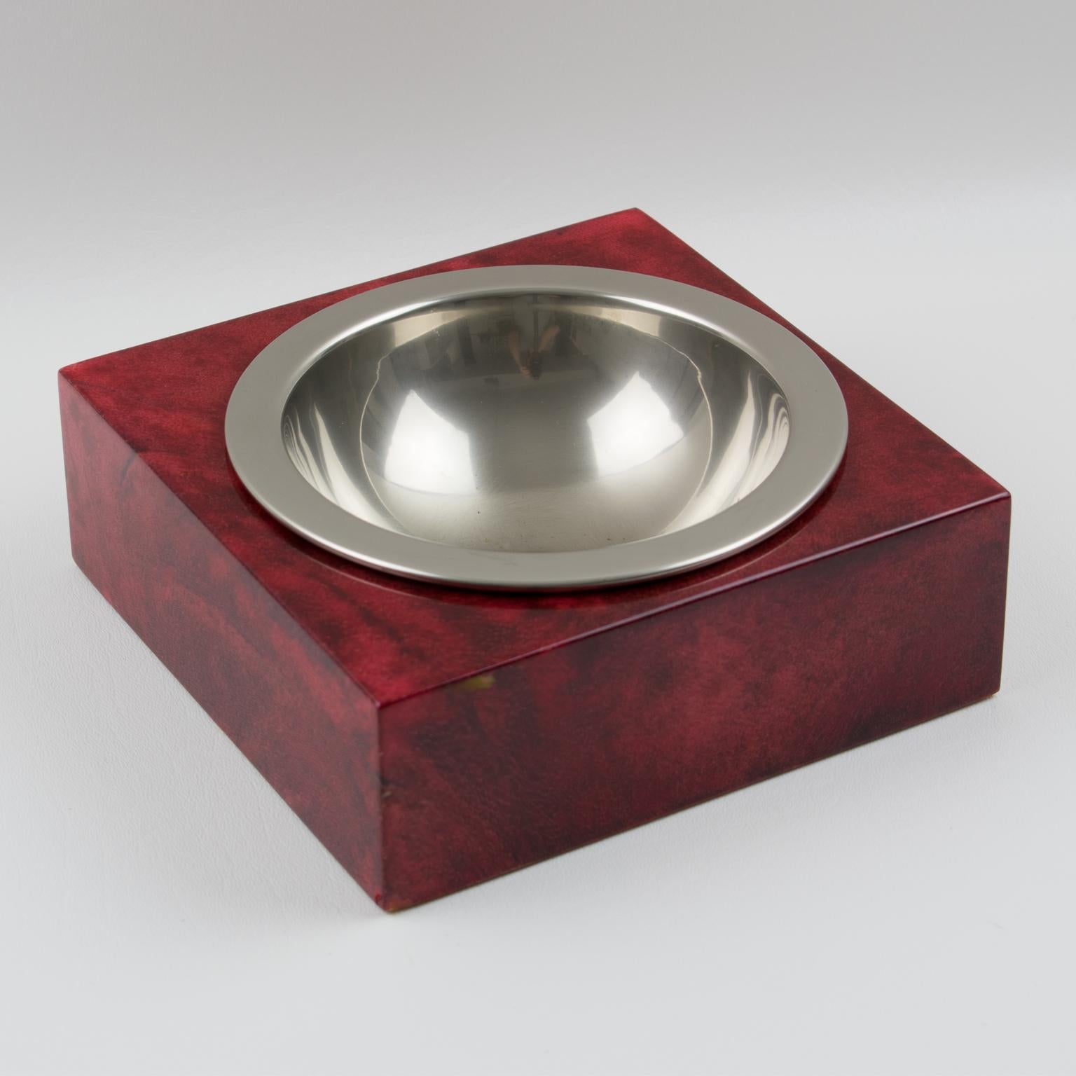 Stunning lacquered goatskin and chromed metal cigar ashtray or desk tidy or catchall by Italian designer Aldo Tura, Milano. A beautiful 1970s square wooden base with lacquered oxblood colored goatskin parchment veneer and a chromed metal inlay.