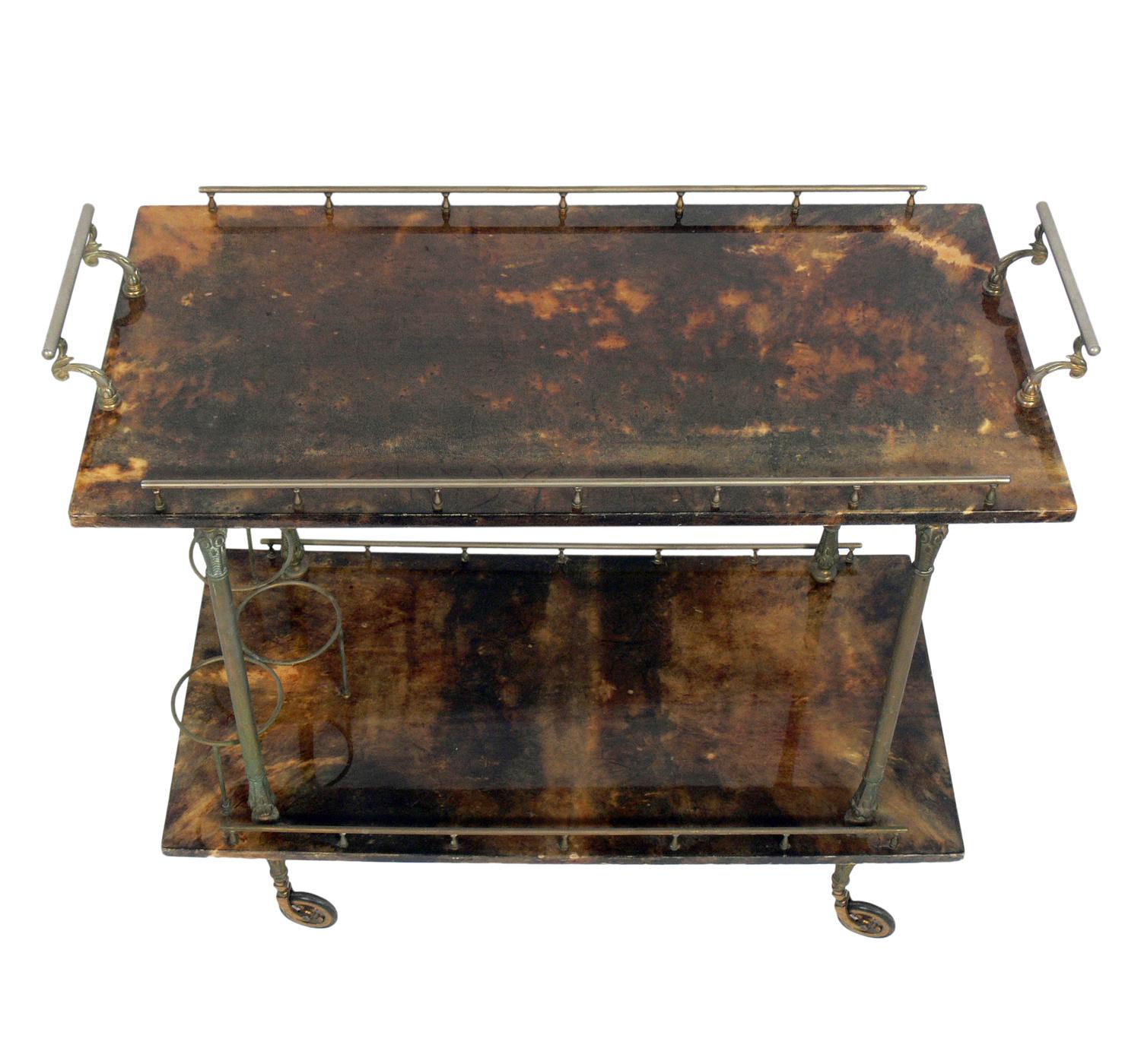 Aldo Tura Goatskin or parchment bar cart, Italy, circa 1960s. Constructed of thickly lacquered goatskin or parchment and gilt metal hardware. Perfect bar or serving cart, or as rolling storage in an office.