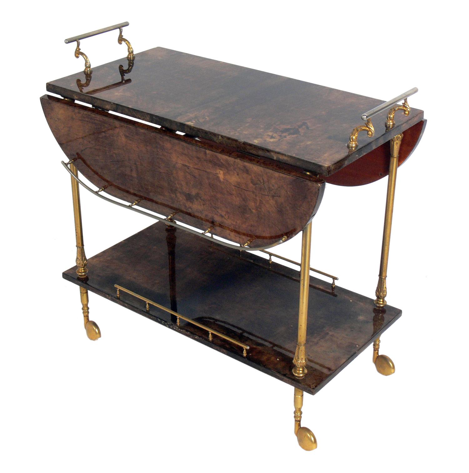 Aldo Tura Goatskin or parchment bar or tea cart, Italy, circa 1960s. Constructed of thickly lacquered goatskin or parchment and gilt metal hardware. Perfect bar or serving cart, or as rolling storage in an office.