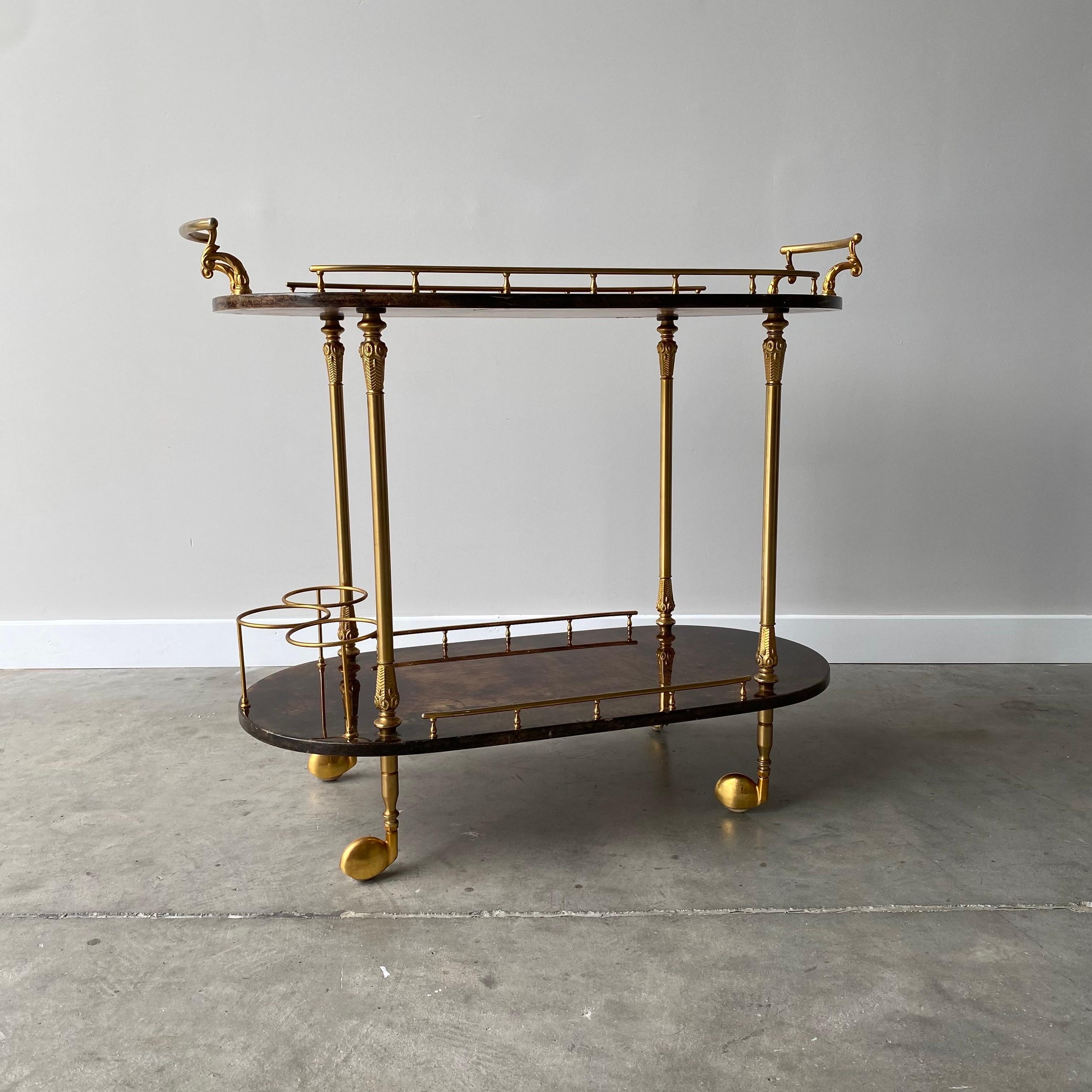 Un superbe chariot de bar d'Aldo Tara datant des années 1960.  Parchemin en peau de chèvre brun vif, finition laquée et quincaillerie en laiton.  Signé au verso.

La finition laquée présente des éraflures apparentes, comme le montrent les