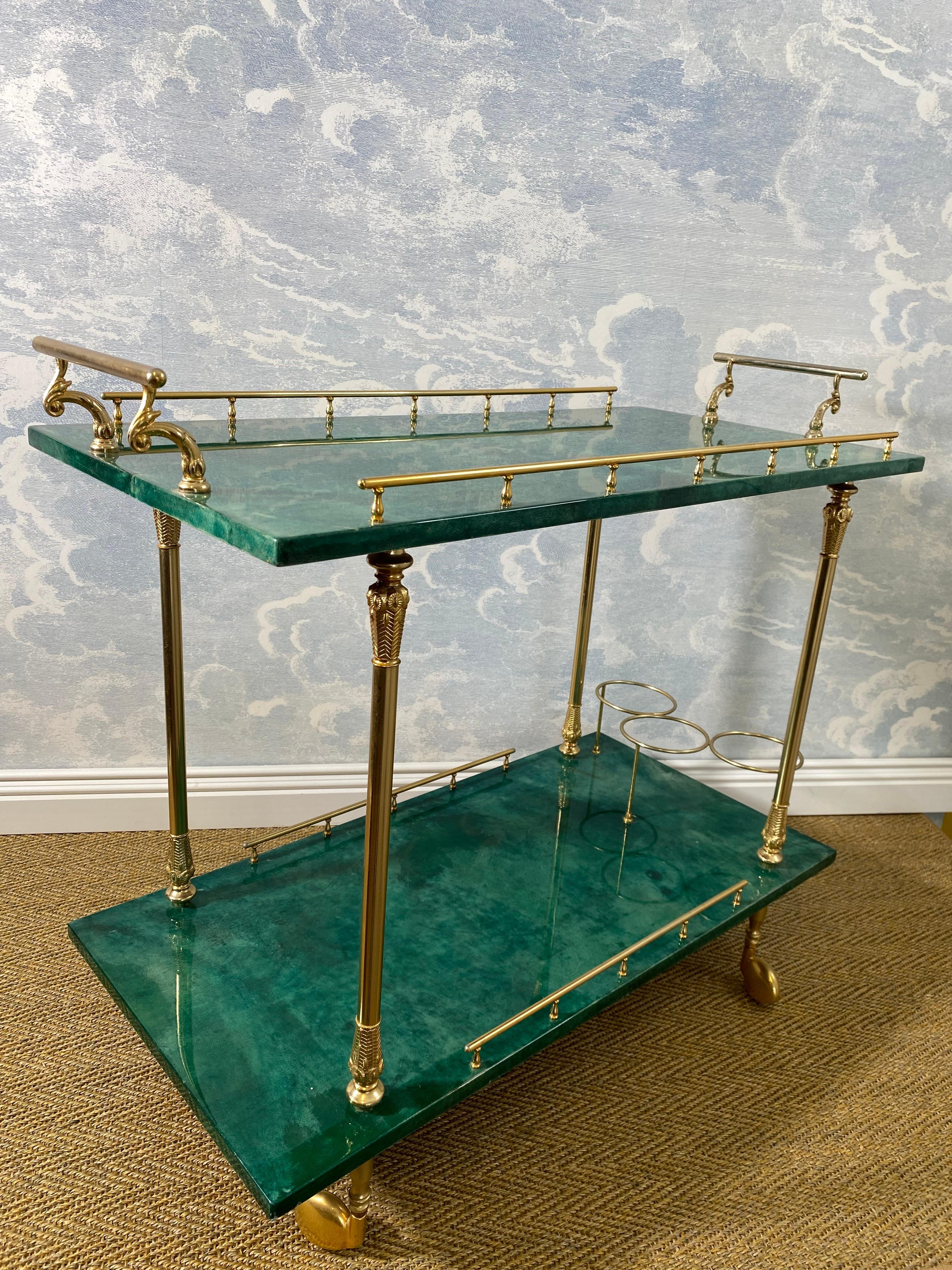 We love Aldo Tura bar carts! Check out our shop for a vast selection! This neat example sets itself apart from others by the great condition it is in. 

Made in Italy the 1960s, the marble-like dark green lacquered goatskin covered surfaces are