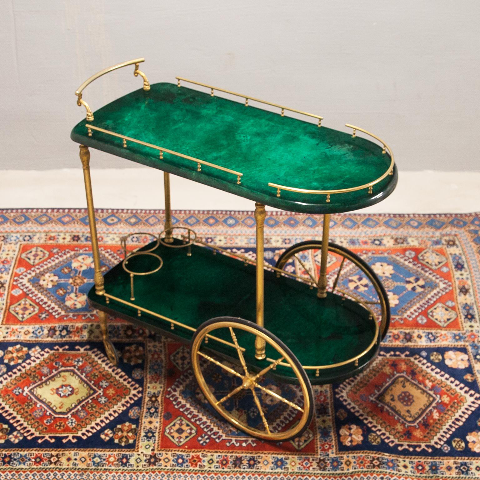 Bar Cart made by Aldo Tura in green lacquered goatskin and a bottle holder from 1960s, in excellent condition, new polished, no scratches.
Along with artists like Piero Fornasetti and Carlo Bugatti, Aldo Tura (1909-1963) definitely belonged to the