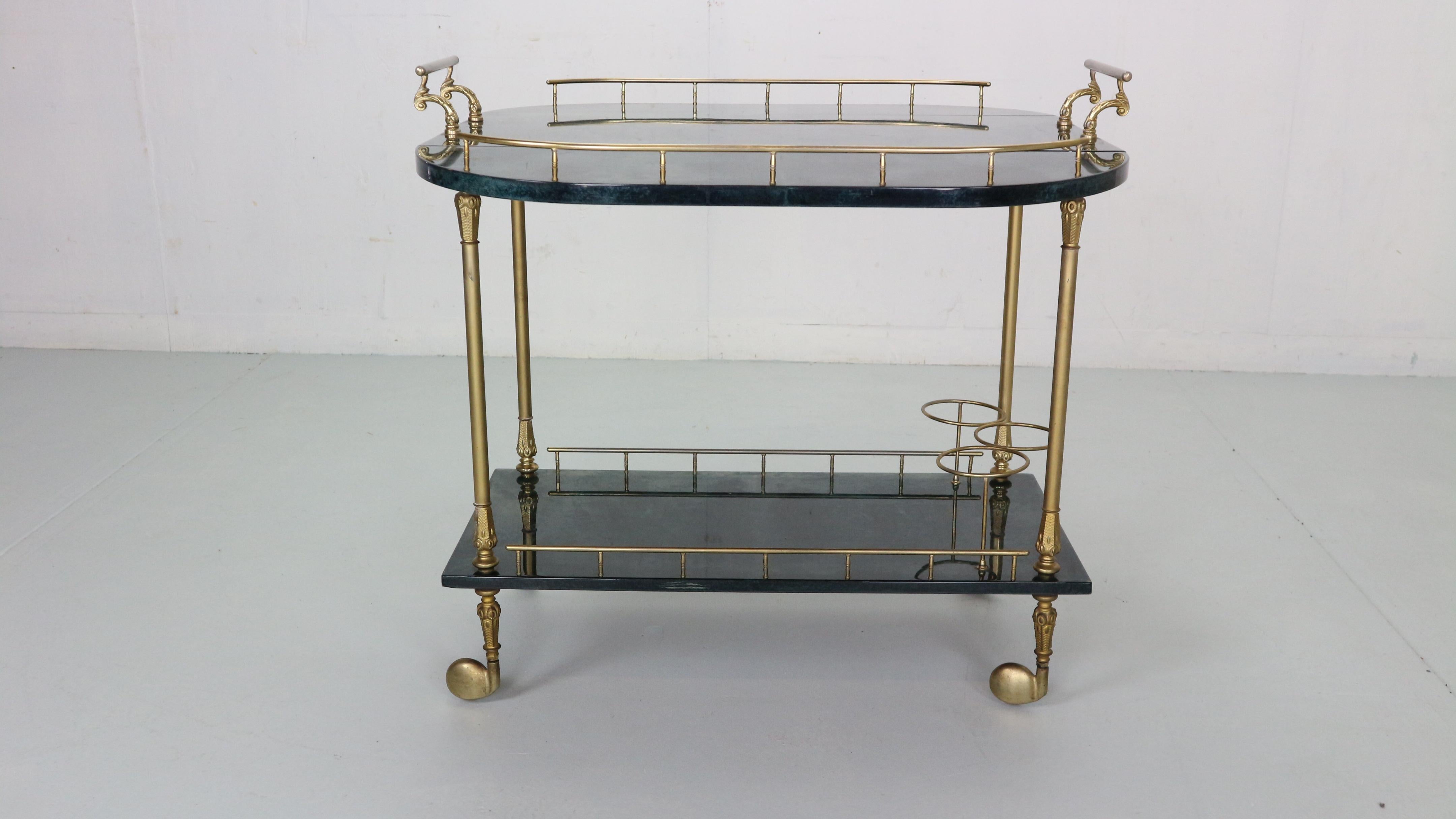 Magnificent bar cart/ trolley designed by Aldo Tura in 1950's period Italy.
Green colour bar cart is made of goat skin witch gives incredible green shades with brass elegant handles, wheels, feet, three bottle holders and details overall.
The top