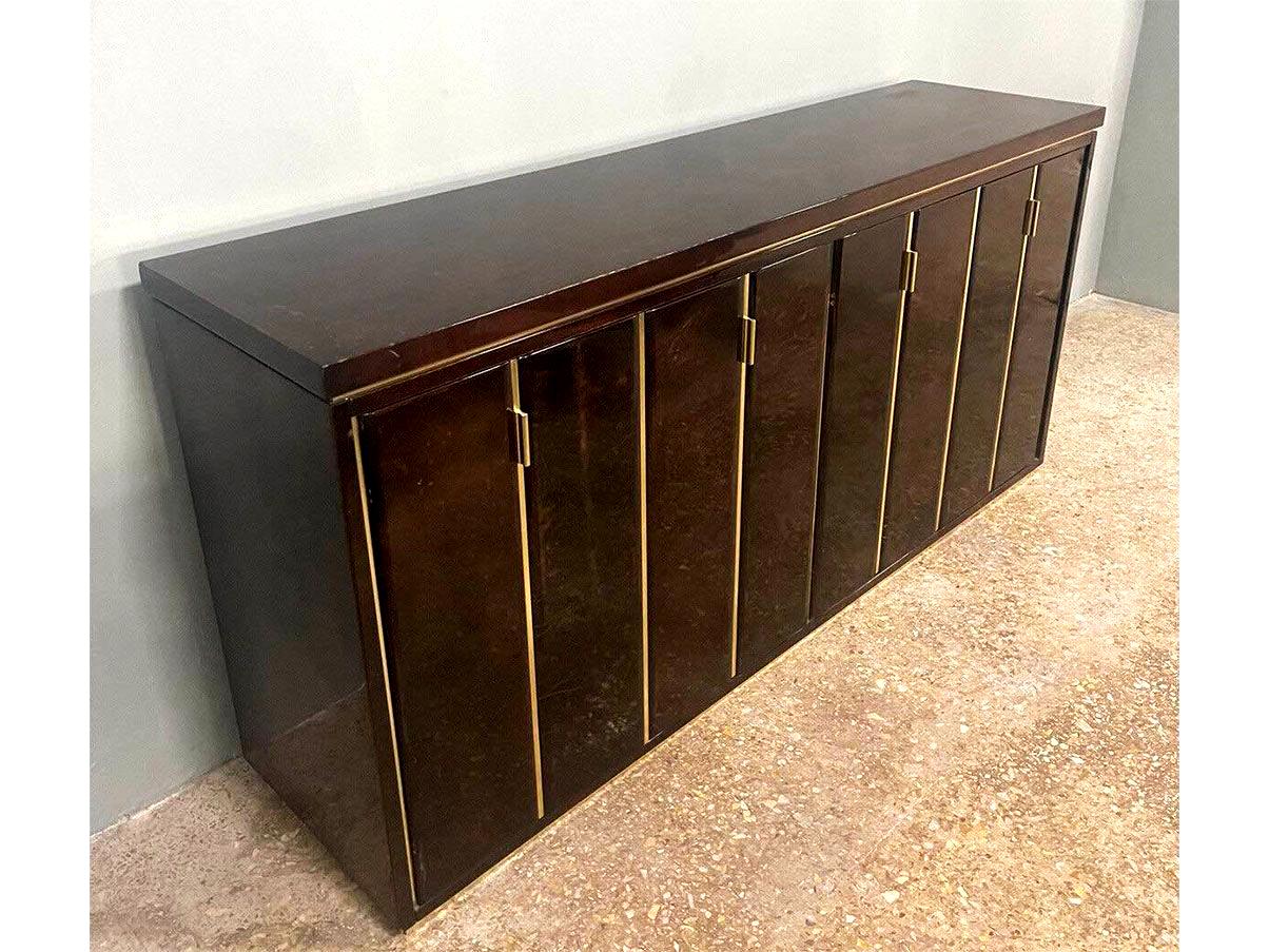 Introducing the Aldo Tura Credenza - a stunning piece of furniture that's guaranteed to elevate the style and sophistication of any room. Crafted in 1960 from goatskin lacquer and brass, this exquisite credenza is a true masterpiece that seamlessly