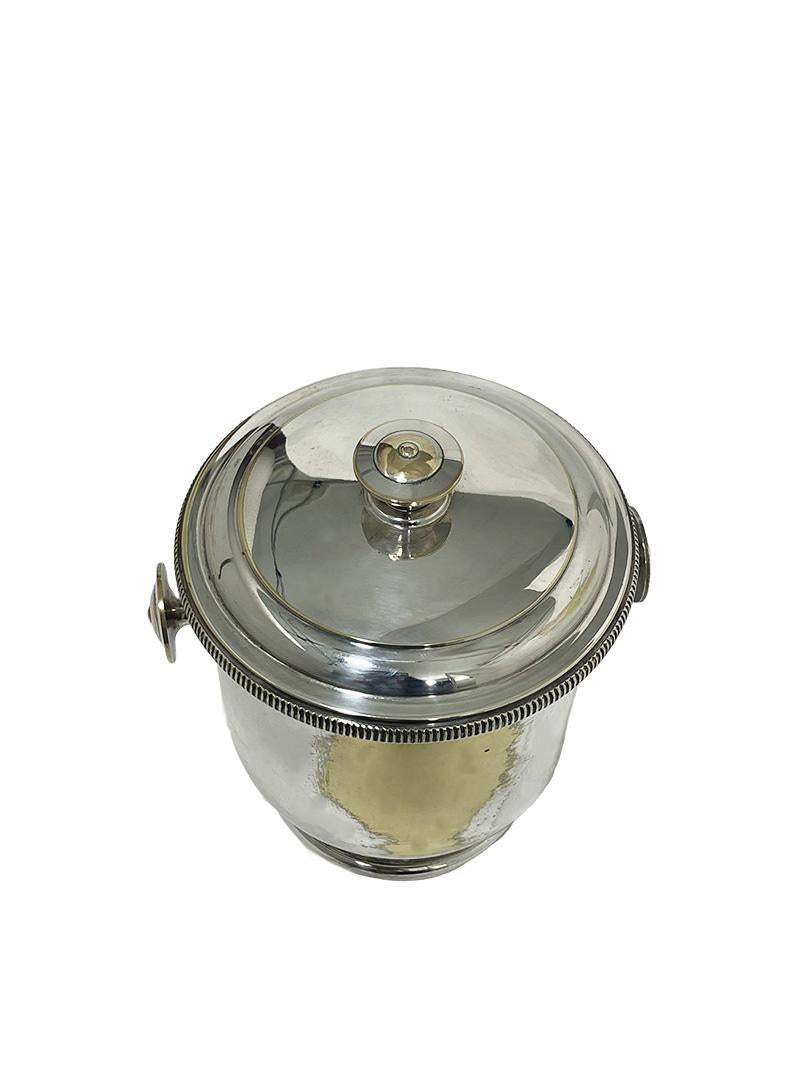 Aldo Tura Ice bucket for Macabo Italy, 1950s

An Ice-bucket made of brass, plated (shows ware) with round knobs. One on top and the same shape as handles. In the inside is a double-walled blown glass container in a copper-colored color with a rubber