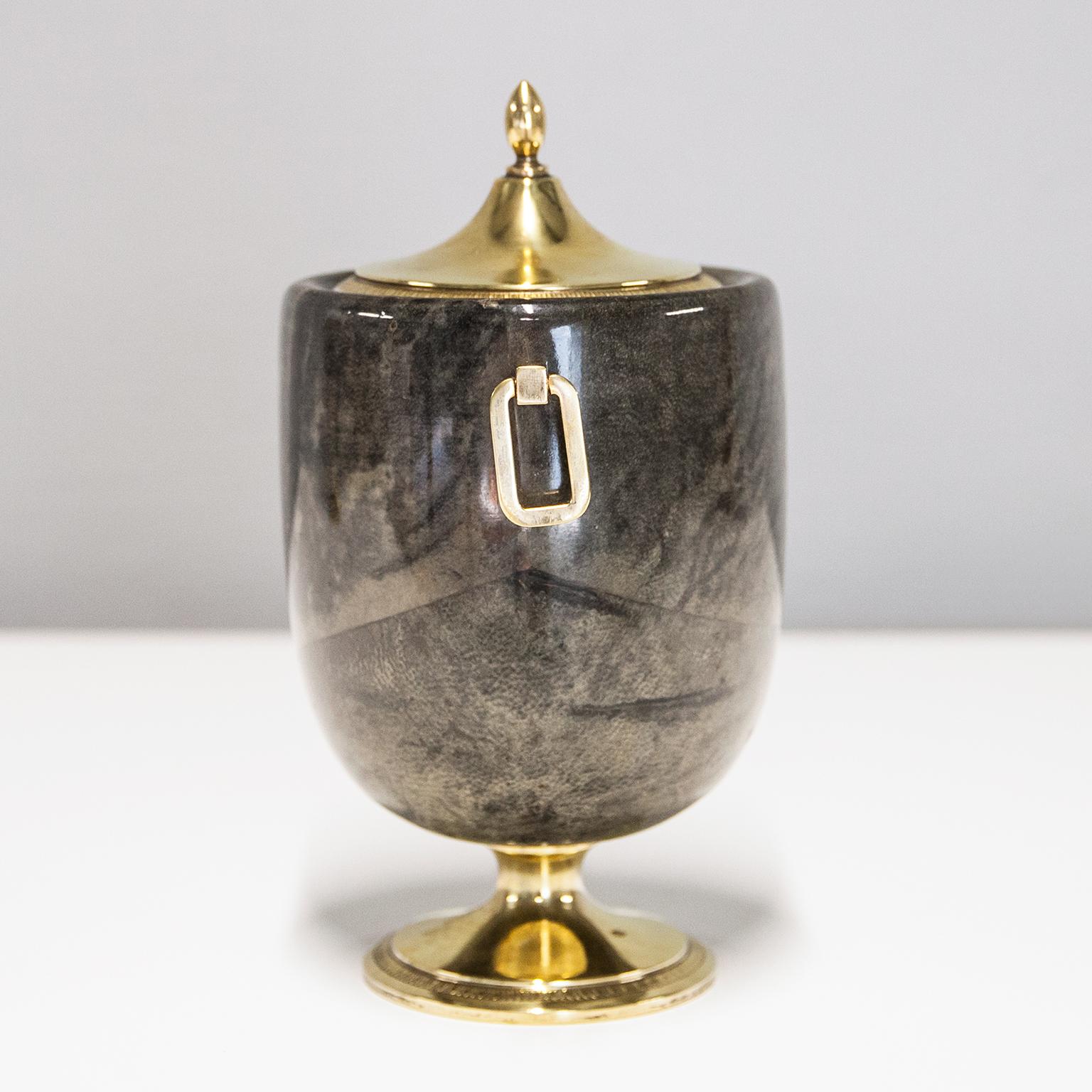 Wonderful ice bucket by Aldo Tura in grey brown parchment and a glass inlay, in excellent vintage condition.
Along with artists like Piero Fornasetti and Carlo Bugatti, Aldo Tura (1909-1963) definitely belonged to the mavericks of Italian design.