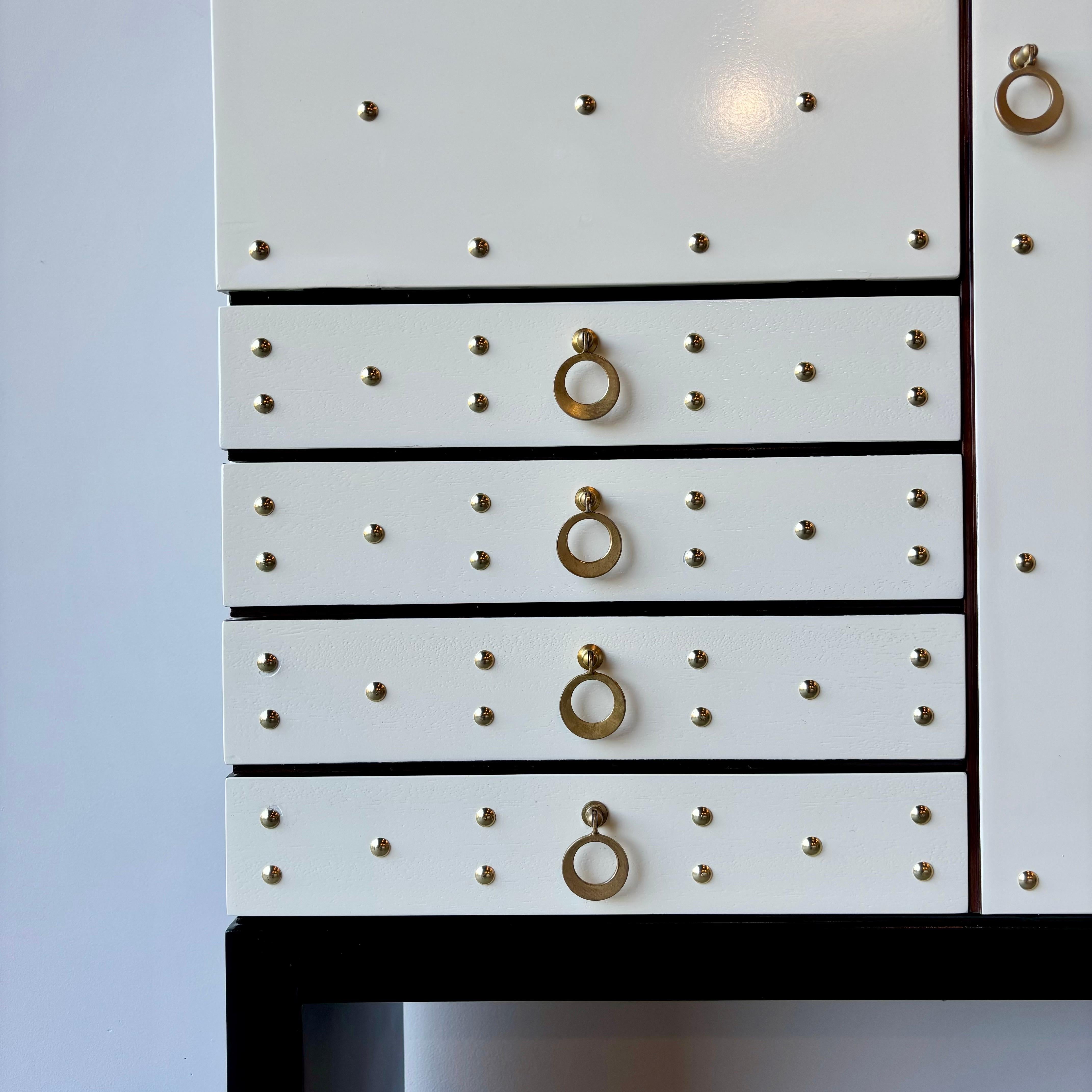 A striking mid century dry bar by Aldo Tura.  Fully lacquered, brass accents abound with fully lighted, mirrored interior.  This incredible design speaks for itself, loudly.  The lacquer shows its age with minor imperfections and fissures.  The