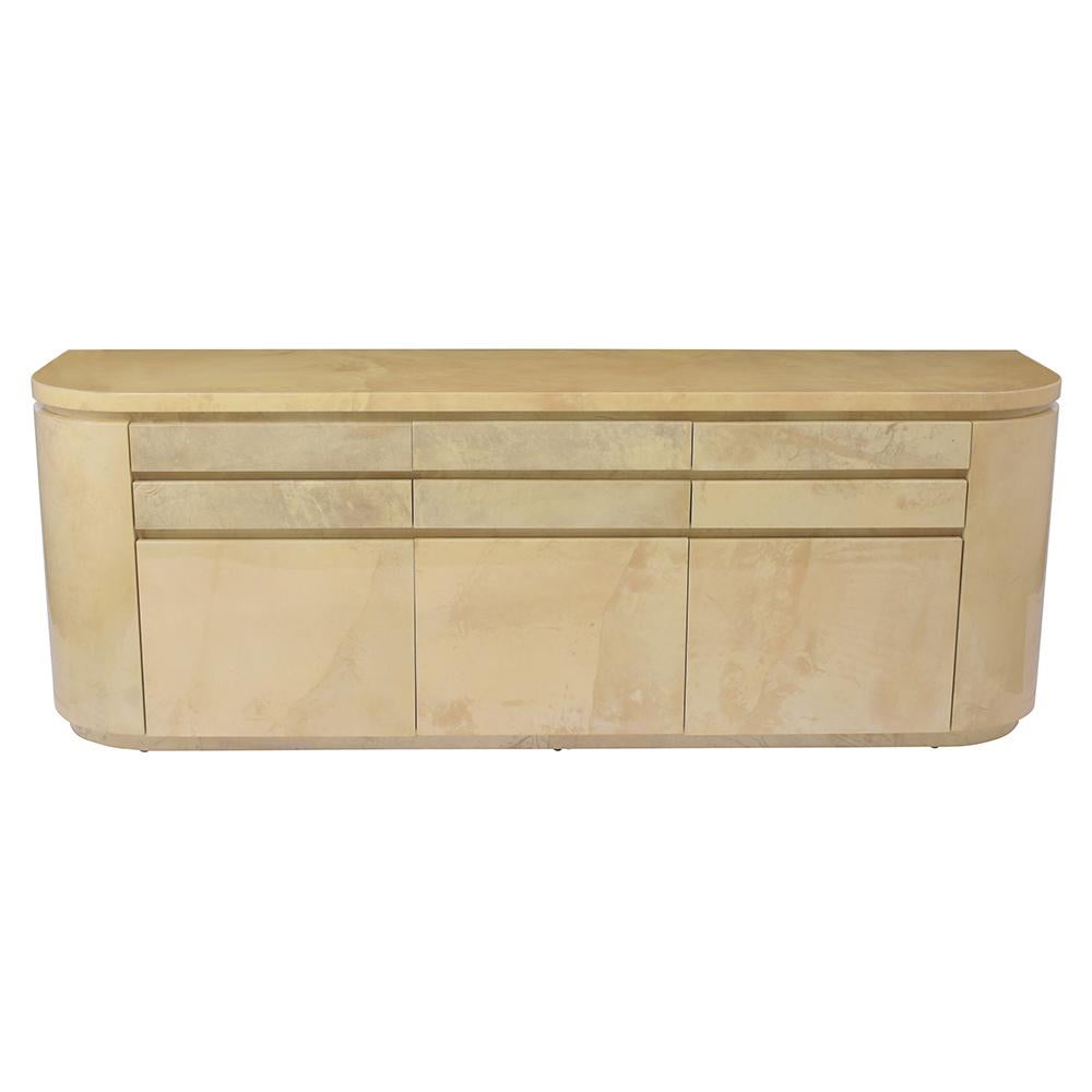 An Extraordinary 1970's Italian Credenza handcrafted out of maple wood covered in a dyed goatskin with a lacquered finish. This beautiful vintage buffet features a curved sides design, six drawers, three doors, and adjustable shelves with plenty of
