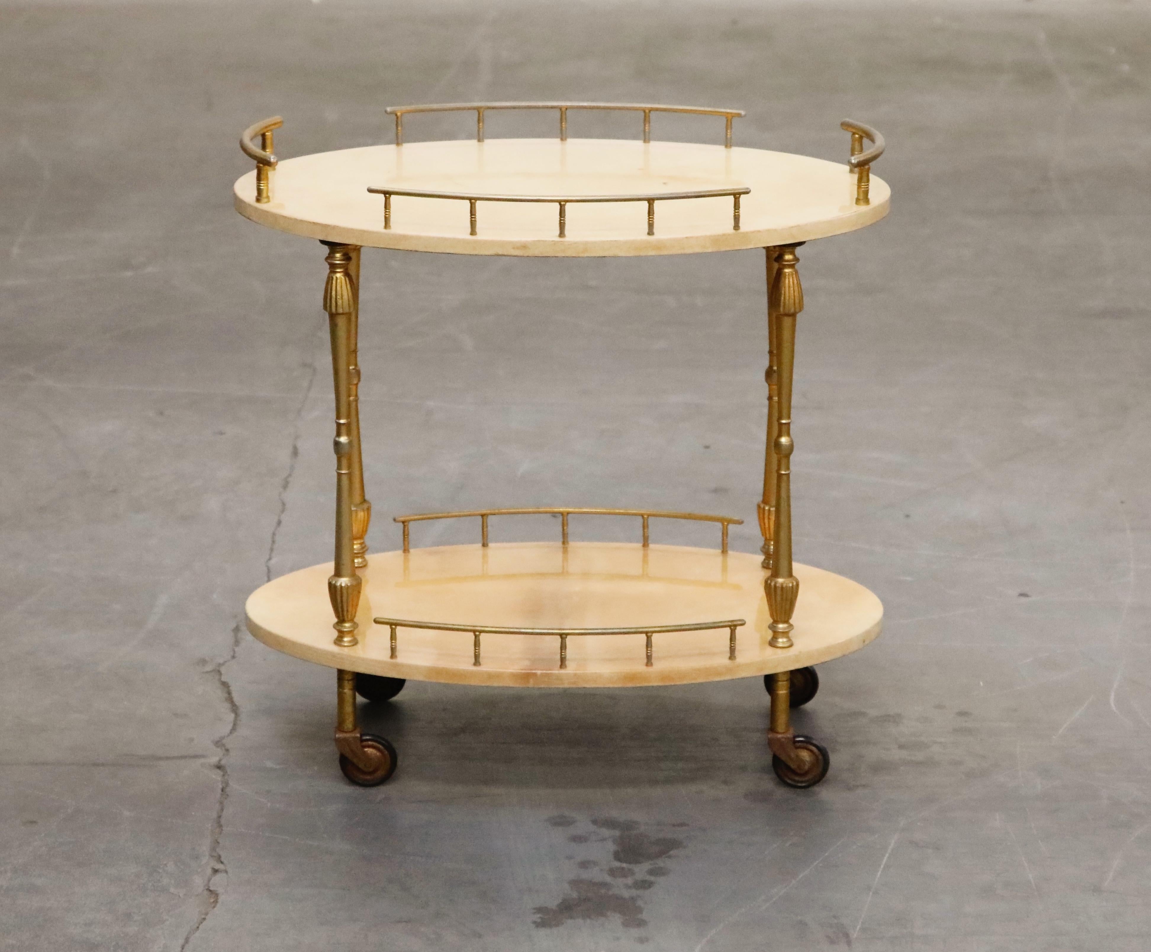 Beautiful bar cart by Italian artist-craftsman Aldo Tura, featuring the designers distinct use of brass and lacquered goatskin that Tura was well-known for. The quality of Aldo Tura's craftsmanship can be attributed to the fact that his work was