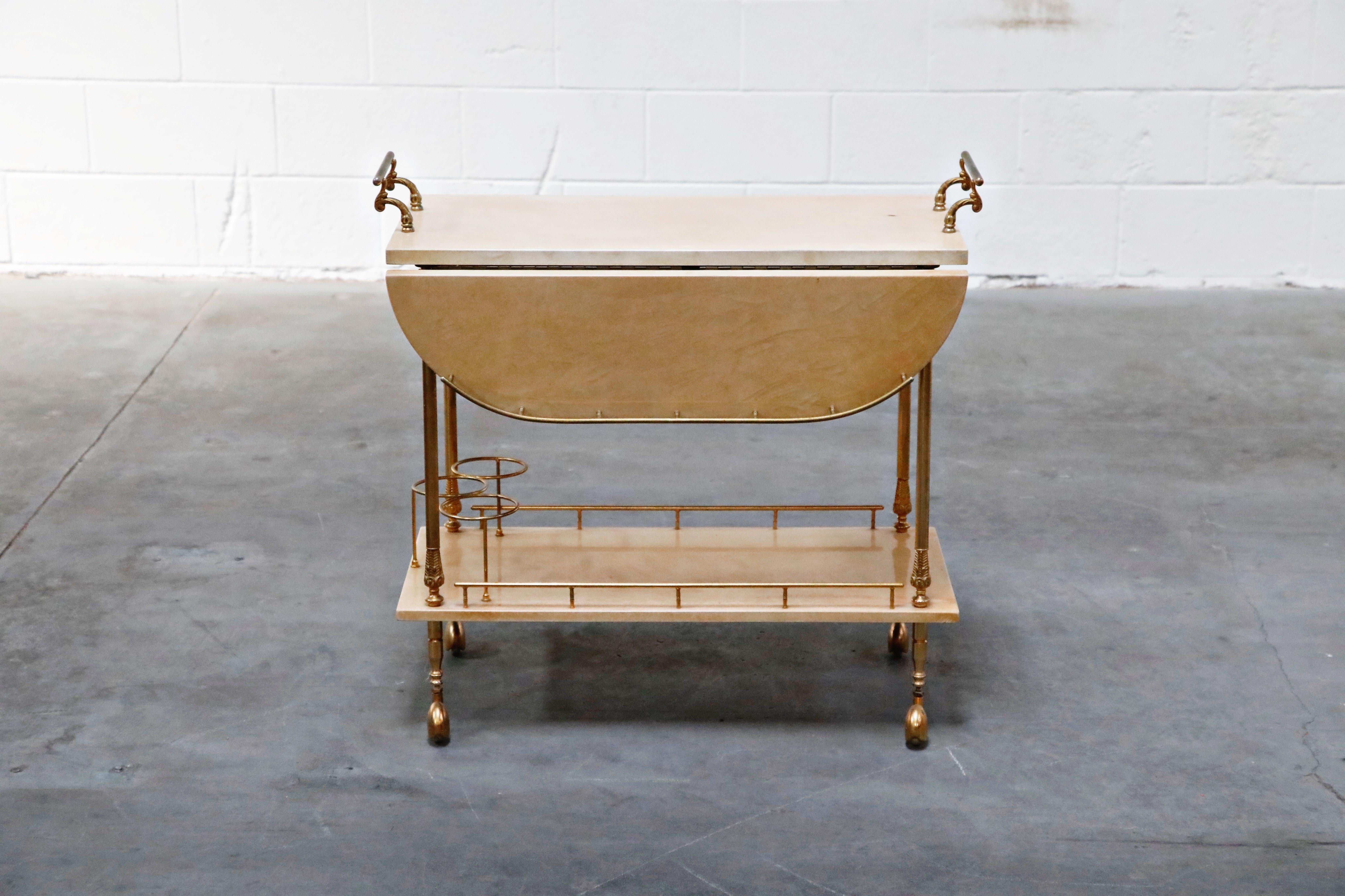 Beautiful bar cart by Italian artist-craftsman Aldo Tura, featuring the designers distinct use of brass and lacquered goatskin that Tura was well-known for. The quality of Aldo Tura's craftsmanship is due to the fact that his work was only produced