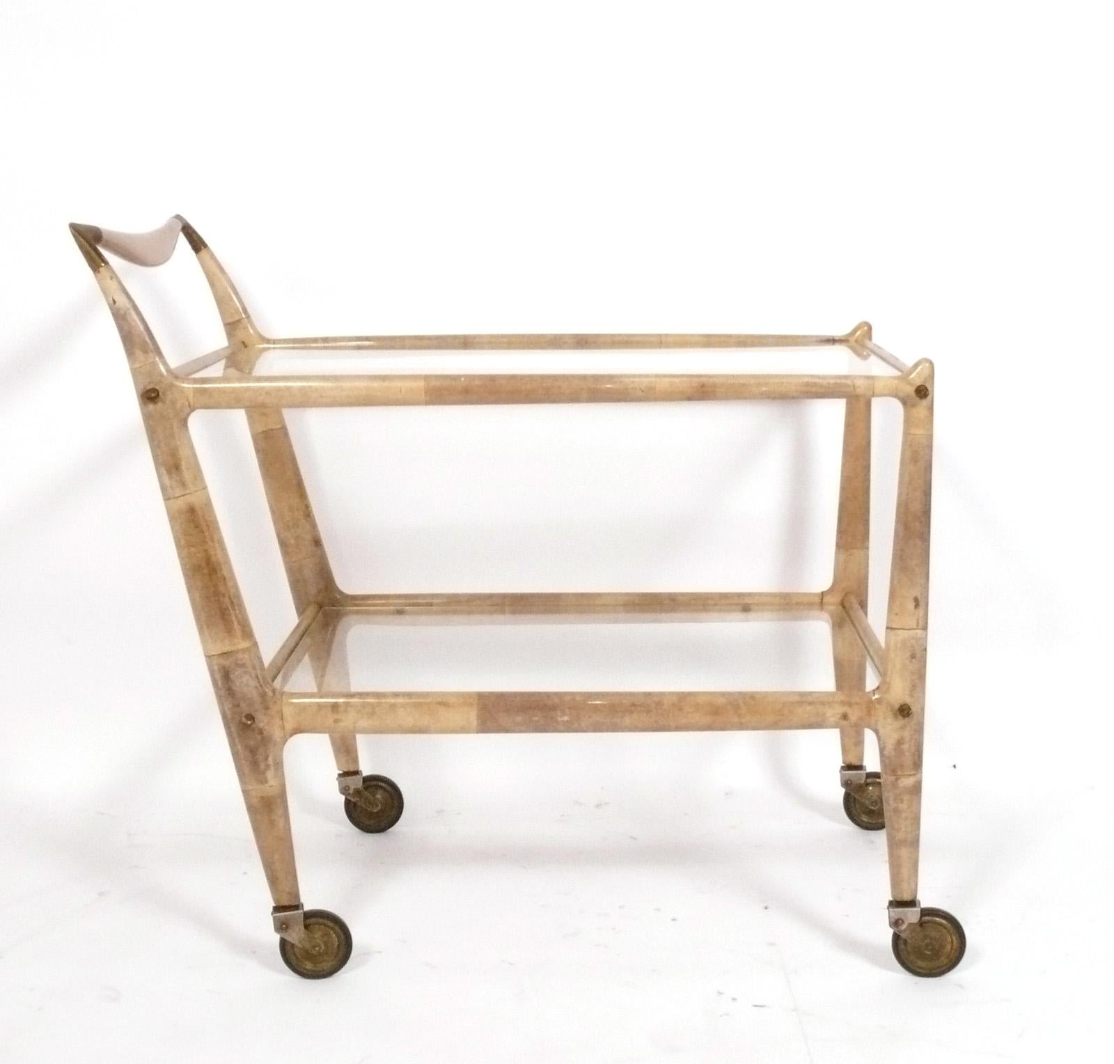 Glamourous Lacquered Goatskin Bar Cart, designed by Aldo Tura, Italy, circa 1960s. It is a versatile size and can be used as a cocktail bar or serving cart, or as rolling storage in a home office. 