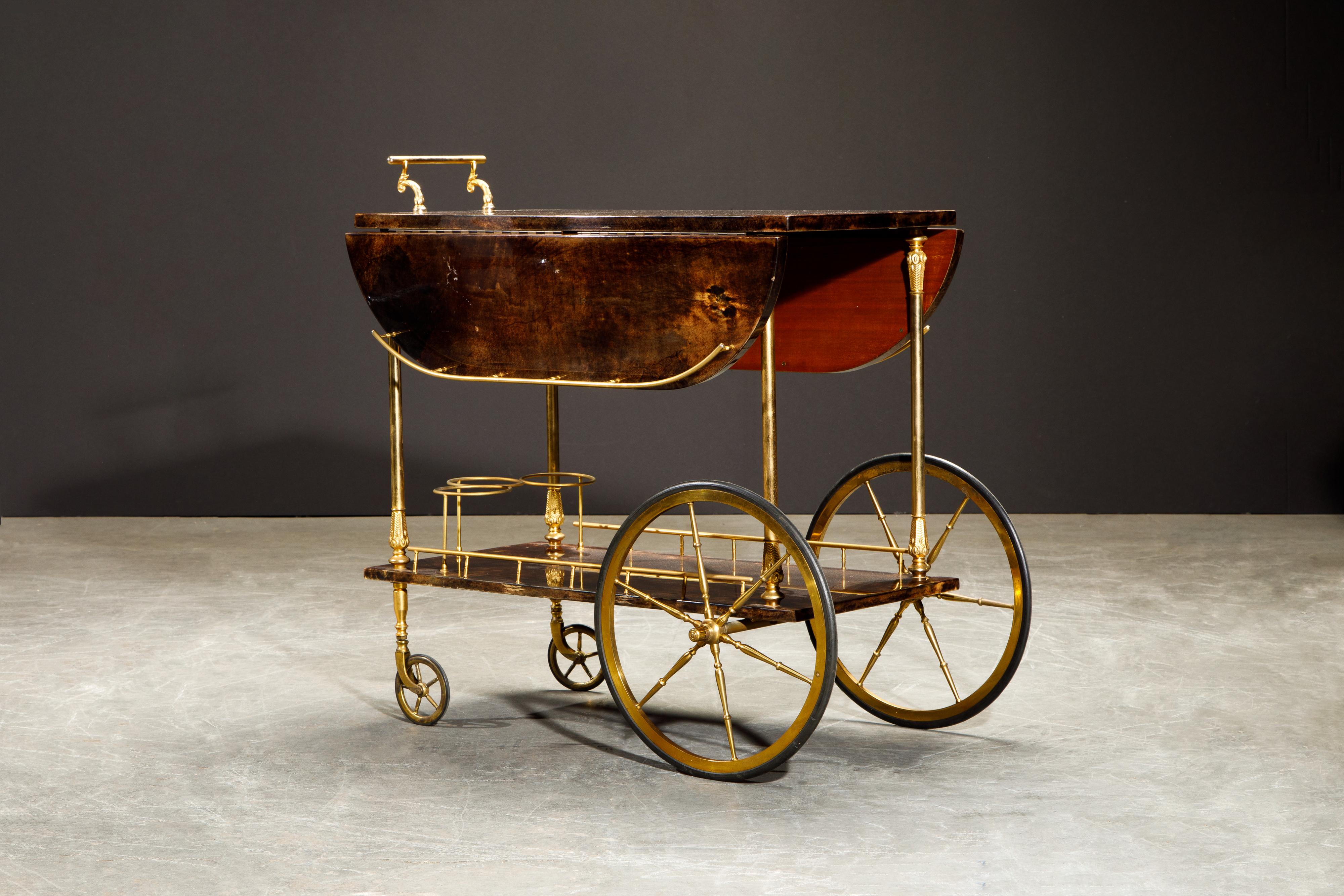 Beautiful 1950s bar cart by Italian artist-craftsman Aldo Tura, signed underneath with Aldo Tura sticker label, featuring the designers distinct use of brass and deep brown lacquered goatskin that Tura was well-known for. The quality of Aldo Tura's