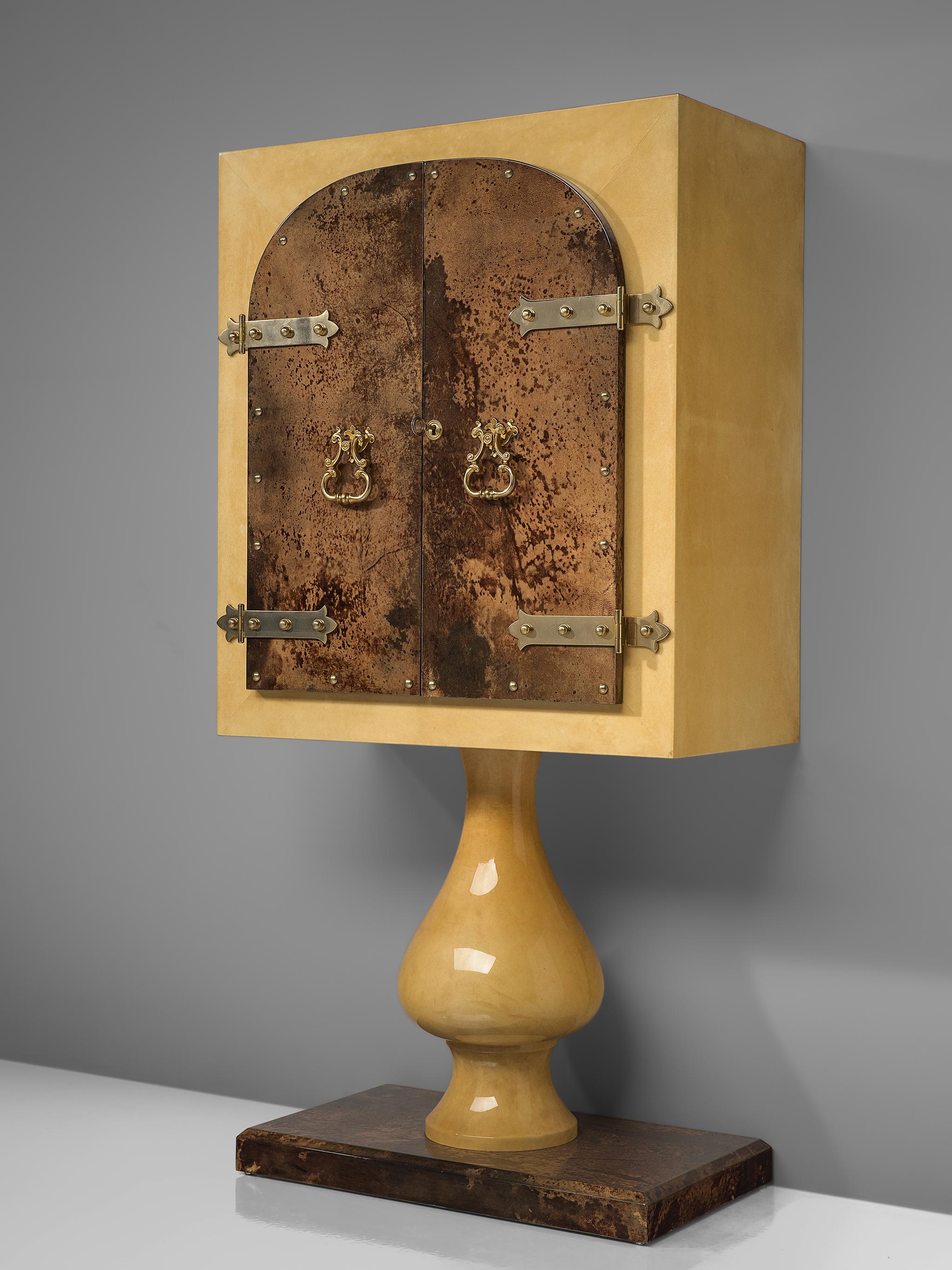 Aldo Tura, lacquered goatskin pedestal bar cabinet, lacquered wood, goatskin and brass, Italy, 1950s.

Decorative cabinet designed by Italian Aldo Tura in the 1950s. It has been finished with a high gloss lacquer. Under this layer a stained goatskin