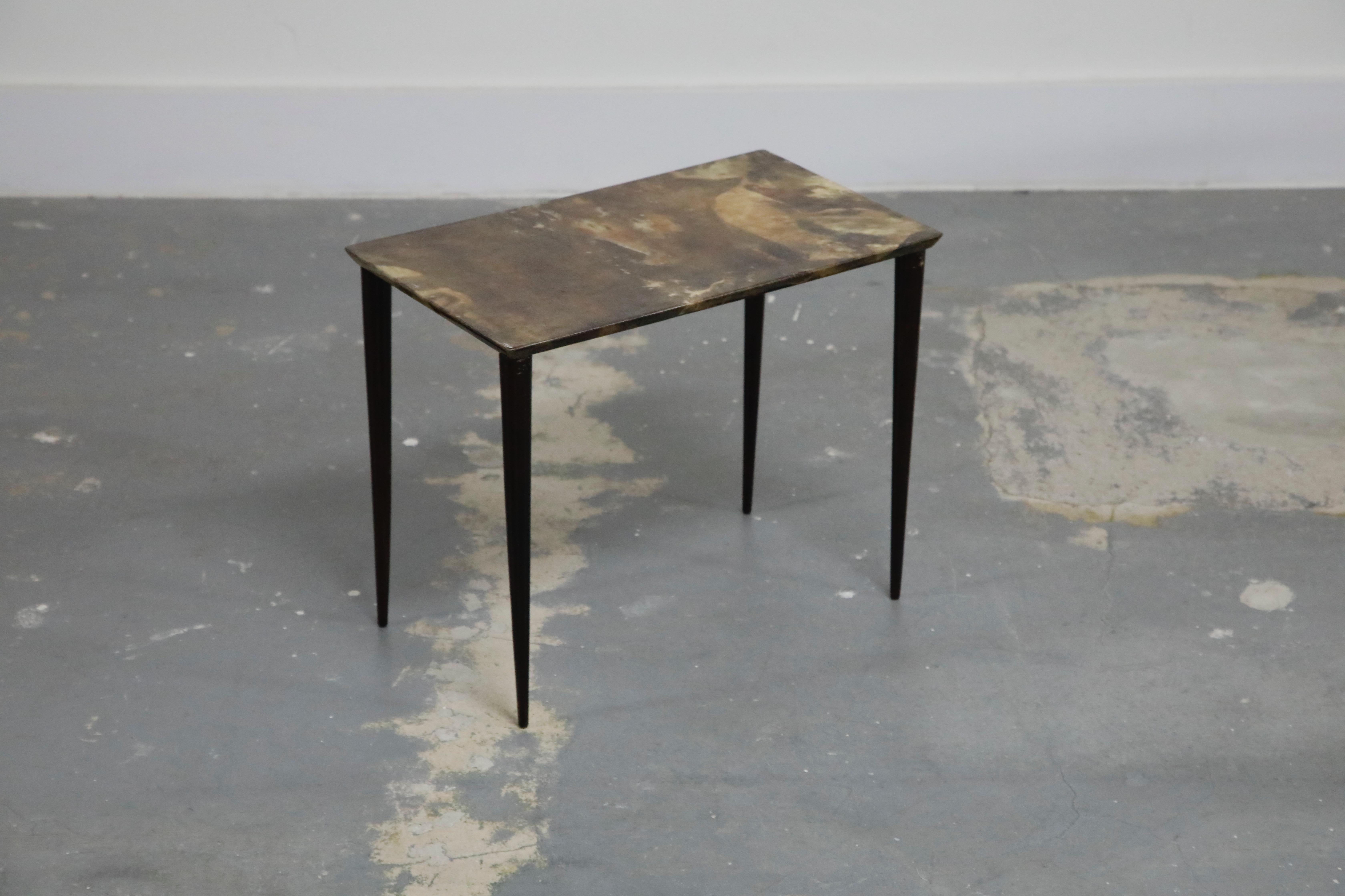A lovely Aldo Tura lacquered goatskin side table, produced in the 1950s in Italy. This Mid-Century Modern collectors piece features thin black conical legs with a gorgeous and luxurious deep brown lacquered goatskin top. 

Perfect for the interior