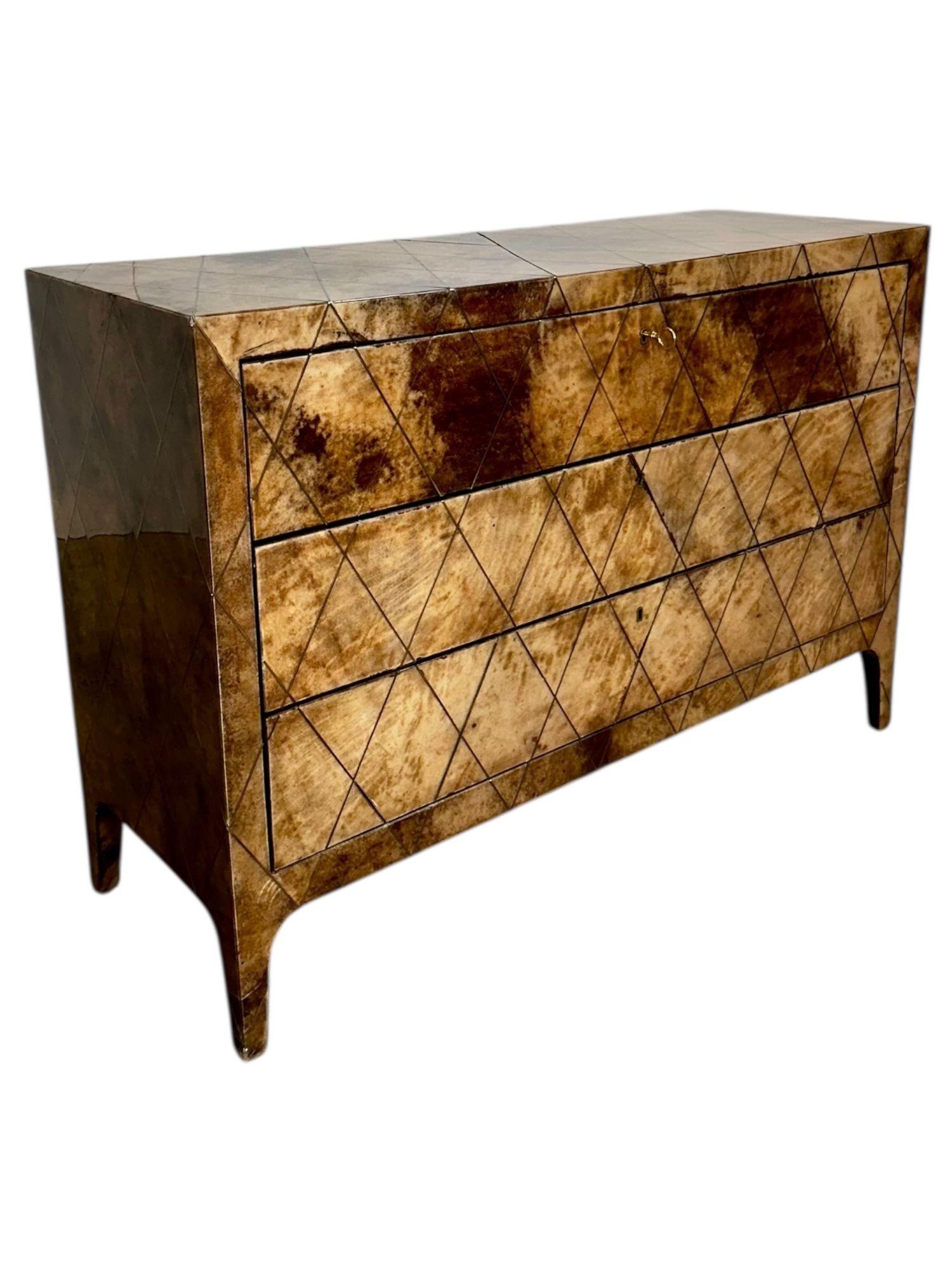 Aldo Tura Lacquered Goatskin w/brass Inlay 3 Drawer Dresser, Italy 1970.  As shown in pictures the brass is inlaid throughout the dresser.  Original condition with original key.
Measures 33.5” tall 48.25” wide 17.25” deep