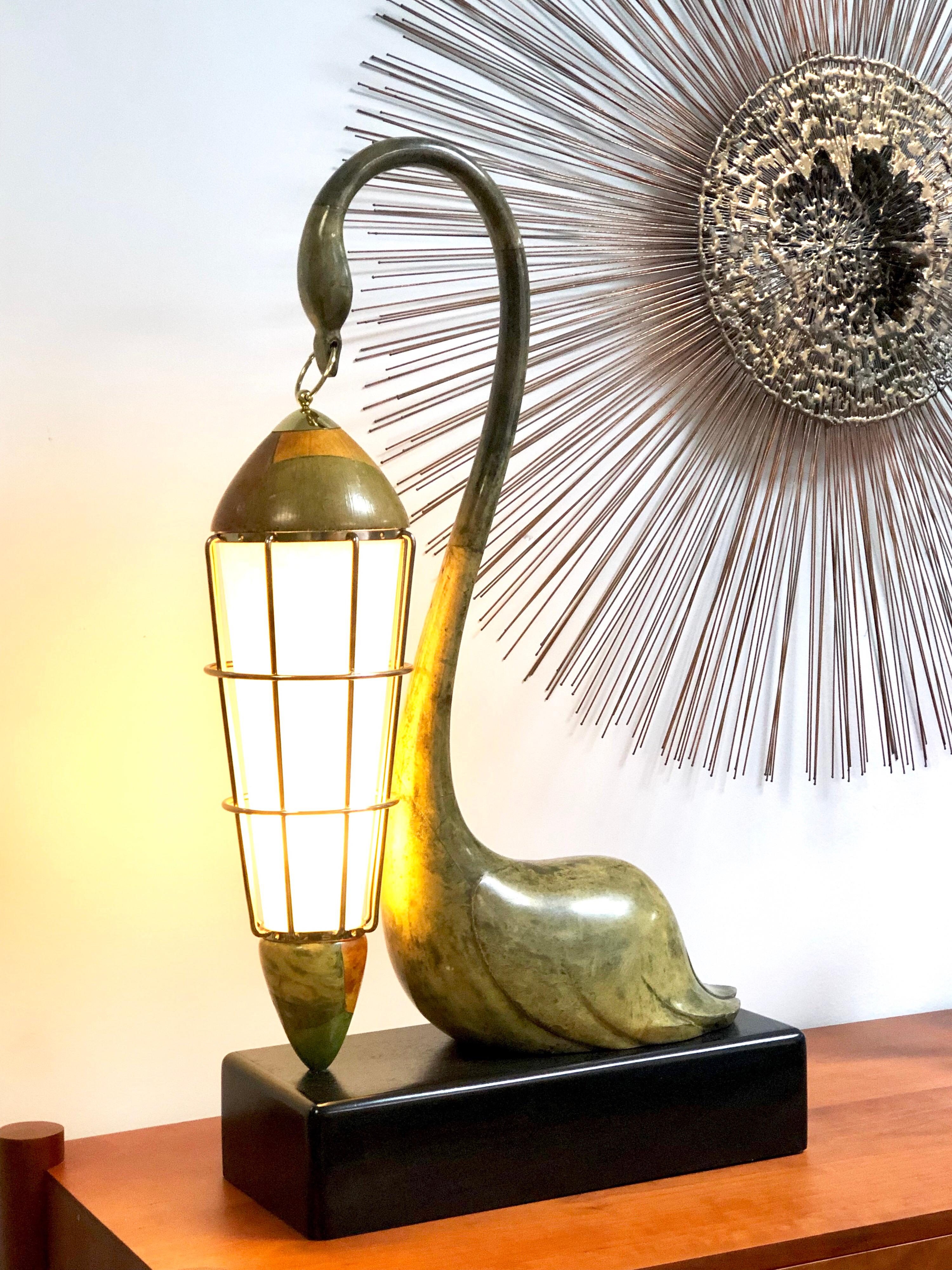 A very graceful and modern table lamp by Aldo Tura. The body of the swan is done in goatskin. Brass accents. New parchment paper diffuser.